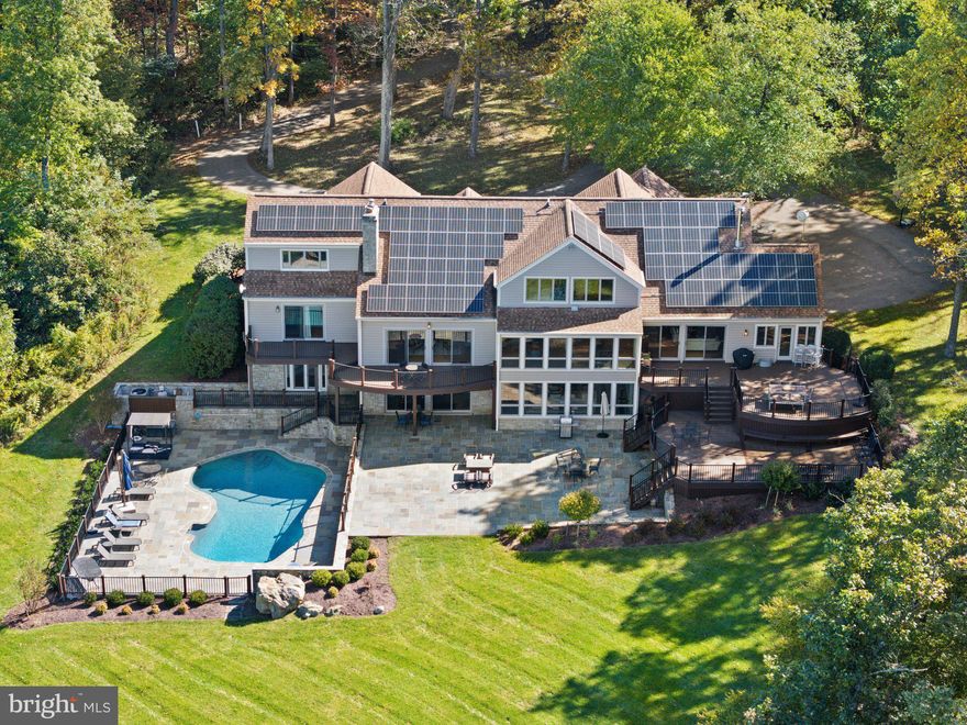 Views, views, views! Enjoy your dream Blue Ridge Mountain retreat on 96+ acres situated just North of the charming village of Paris. When you enter this custom-built contemporary home, you are greeted by expansive windows with sweeping views of the Shenandoah Valley. This turn-key residence features tongue and groove vaulted ceilings, gleaming hardwood floors and wrought iron accents that complement the open floor plan. Offering 6 bedrooms and 4.5 baths this home beautifully integrates modern living with thoughtful architectural elements. Step down into the formal living room with built-in bookshelves that surround a floor to ceiling stone fireplace. The gourmet kitchen has high-end appliances, a peninsula style granite topped counter with seating along with a breakfast area and a formal dining room – all that enjoy the spectacular views. Just off the kitchen is the family room with a wood stove and a sunroom. Adjacent to the family room is a separate laundry room that leads to the attached 2-car garage. Completing this level is a separate home office and the primary bedroom suite with a fireplace, separate deck, two walk-in closets and a luxury bath with double vanities, a soaking tub with sky lights and a separate shower. From this main floor, there are doors opening onto the multi-level decks which have stairs leading down to the large flagstone terrace and the fenced heated pool. The upper level has 5 more bedrooms, two full baths and another office suite or sitting area. The lower level has new LVP flooring and a wall of windows and doors out on to the open flagstone terrace. This level features an exercise room, a game room area with a TV that opens to the recreation room with a stone fireplace and small mini-bar area. Finishing this level is a sitting room, a bonus room, a mudroom area with a full bath ideal for when you are coming in from the pool. This home provides plenty of spaces to gather. Multiple decks along with the expansive flagstone terrace and heated swimming pool extend your lifestyle from indoors to out with incomparable valley views to share with friends and family.  Other outbuildings include an impressive warehouse that was fully renovated by the owner into a recreation and study place. This space offers open classroom settings, a separate conference room, small kitchen, his & her powder rooms, an open upper-level space and a basketball hoop. A unique frosted garage door along with bi-folding doors allows one to open the space and bring the outside in. Both this warehouse and the guest house have a separate driveway for privacy from the main house. The 1-bedroom, 1 bath guest house has an open floor plan with a kitchen with an island, a dining area and a living room with a wood stove. There is a covered front porch, a screened-in back porch, a full unfinished walk-out basement and a 1-car attached garage. While this parcel is mostly wooded, there are walking trails throughout, a year round creek and access to the Appalachian Trail. Great commuter location with easy access to both Routes 50 and 7, just 40 minutes to Dulles International Airport and 1-hour to downtown Washington DC. If you are looking for a home that harmoniously fuses modern living and natural serenity, then come discover this mountain home nestled within the beauty of its surroundings. Be sure to watch the video!