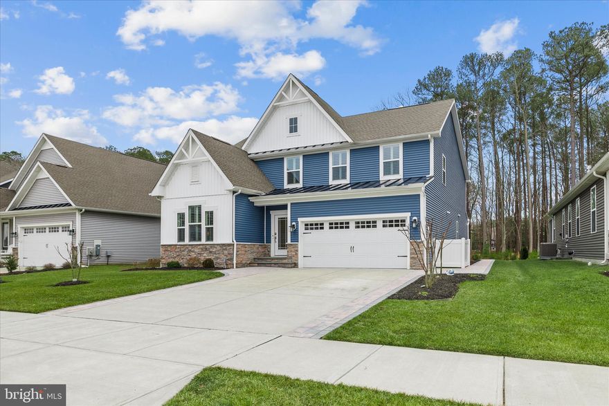 Enjoy upscale coastal living in this beautiful NV Homes Stapleton model, located in the resort-style community of The Estuary. This five-bedroom, four-bath home backs up to a premium wooded area and is perfectly situated between Bethany Beach and Fenwick, with a seasonal shuttle available to take you directly to Bethany Beach.

The property has been extensively enhanced for comfort and style. The interior features LVP flooring, upgraded carpeting, elegant crown molding, and custom trim work. The gourmet kitchen and primary bathroom boast Cambria quartz countertops, upgraded lighting with dimmers, and soft-close cabinetry. Additional highlights include plantation shutters throughout, under-cabinet lighting, and a shiplap accent wall in the primary suite.

The exterior and utility features are equally impressive:

  - A 16x24 custom screened porch and an extended paver driveway.
  - Professional landscaping with irrigation, buried downspouts, and leaf filters.
  - A finished, painted garage with Pinnacle floors.
  - System upgrades including a whole-house surge protector and an encapsulated, conditioned crawl space.

Designed for main-level living, the floor plan includes a seamless foyer and dining room, a dedicated study, and a spacious great room. The luxury owner's suite is tucked away for privacy, while the second level offers a loft, three additional bedrooms, and two full baths. Please note that select furnishings and wall-mounted televisions are also available for inclusion