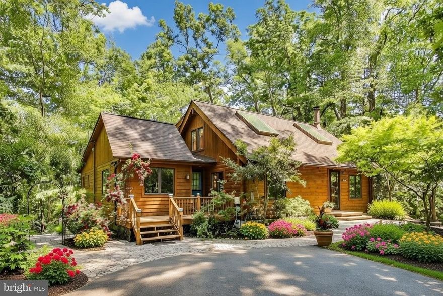 Set on 2.48 private acres with potential subdivision opportunity, this beautiful log home offers the perfect mix of character, space, and thoughtful updates. Surrounded by mature trees and landscaping, the property provides peaceful treetop views and seasonal water views during the winter months. The two-story living room features a striking wood-burning fireplace and opens to the dining area and updated kitchen with granite countertops, breakfast bar seating, ample cabinet space, and all major appliances. The layout is ideal for both everyday living and entertaining. Three spacious bedrooms are located on the main level, all with hardwood floors. The primary suite includes a walk-in closet, ceiling fan, spa-style bath with soaking tub and separate shower, and private access to the rear deck. Upstairs, a bright loft with oversized skylights and a full bath offers flexible space for a home office, family room, or additional living area. The finished basement adds even more usable space with a large recreation room, fourth bedroom, laundry area, and plenty of storage. Enjoy outdoor living on the rear deck overlooking wooded privacy, plus a welcoming front paver walkway and deck. The driveway offers ample parking, and community beach access is just a short walk away. Conveniently located near major commuter routes and downtown Annapolis, this home combines privacy with easy access to shopping, dining, and everyday amenities.