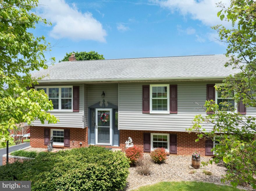 Take a look! 608 Blanchard Street offers a beautiful, move‑in ready split‑entry home with 3 bedrooms, 2 full baths, and exceptional views on nearly half an acre. The home has great curb appeal with a nicely landscaped front yard, a charming brick walkway, and plentiful driveway parking. Inside, hardwood floors warm the living room and hallway. The living area is bright and inviting, flowing easily into the dining space. The kitchen features classic oak cabinetry, generous countertop space, and bar seating. Down the hall, you’ll find a spacious primary bedroom with a private bath, a second full bath, and two sizeable bedrooms. The lower level adds even more flexibility with a versatile rec room, hobby room, workshop, and a dedicated laundry area. Step outside to a covered deck overlooking panoramic views of the fields and mountains—an ideal spot to unwind or entertain guests. Two separate paver patios expand your outdoor living options. Additional highlights include efficient natural gas heat, central air, and fresh paint throughout. Enjoy a convenient location with an easy commute to downtown Bellefonte, State College, and nearby amenities. Call today for a showing!
