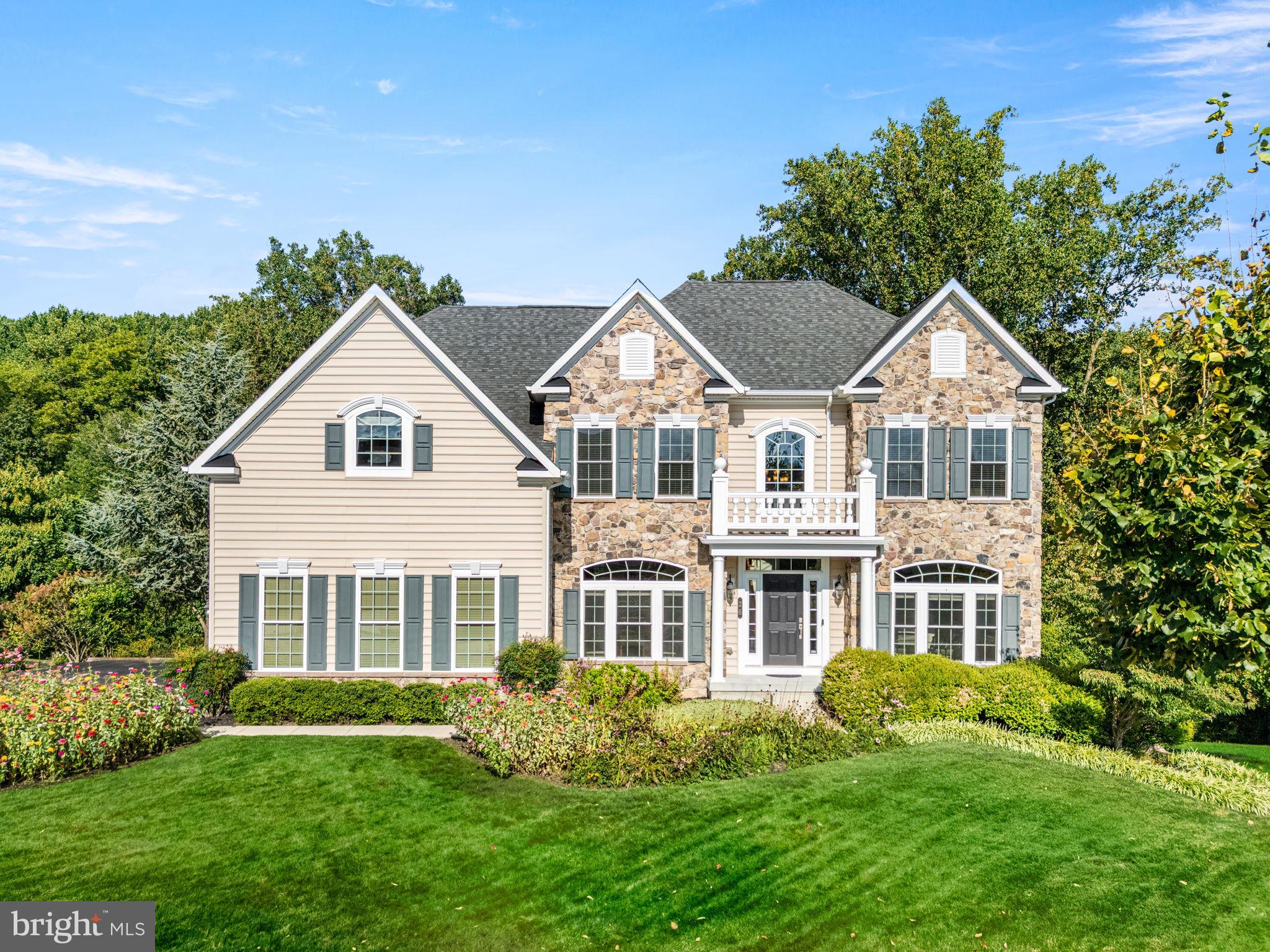 Welcome to 26 Inniscrone Drive, a spacious and beautifully upgraded home in the highly desirable Preserve at Inniscrone golf course community, within the sought-after Avon Grove School District. Offering over 5,000 finished square feet, 5 bedrooms, 4 full bathrooms, a full walkout basement this property combines size, comfort, and luxury with an ideal location. Step inside to a dramatic two-story foyer and an open floor plan with hardwood floors throughout the first level and primary suite. The two-story family room features a custom floor-to-ceiling stone gas fireplace, creating a dramatic yet inviting focal point. The high-end kitchen flows seamlessly to the breakfast room and includes granite countertops, stainless steel appliances, a gas cooktop, and upgraded cabinetry. Step into the bright office off the foyer with double French doors. Rounding the first floor is an ensuite bedroom offering flexibility for guests or multi-generational living, with the full bath also accessible from the hallway. This room would also make a great second home office. Upstairs, the spacious primary suite features a tray ceiling with fan, two expansive walk-in closets, and a spa-style bath with dual granite vanities, soaking tub, water closet, and a therapeutic steam shower. Three additional generously sized bedrooms and a full hall bath complete the second floor. The finished walkout basement is filled with natural light from four full-size windows and double French doors to the lower deck and includes a large recreation area, an additional room that could serve as an office or 6th bedroom, and a full custom bathroom with dual granite sinks and steam shower rough-in. There is also a finished flex room that would make a great yoga or exercise room, and outstanding storage space with ample shelving and a utility sink. Outdoor living is just as impressive, with a multi-level composite deck, new paver patio with custom lighting, natural gas grill hookup, and a fenced yard backing to private wooded space. Additional features include: a freshly painted interior in neutral tones, granite counters in all baths, a security system, Aprilaire humidifier, and central vac throughout. The Preserve at Inniscrone offers a sought-after lifestyle with Inniscrone Golf Club, miles of community walking trails, and a welcoming neighborhood feel, all within minutes of Route 1, Kennett Square, Longwood Gardens, and Delaware shopping. Do not miss this opportunity to own one of the largest and most improved homes in the neighborhood. Schedule your showing today!