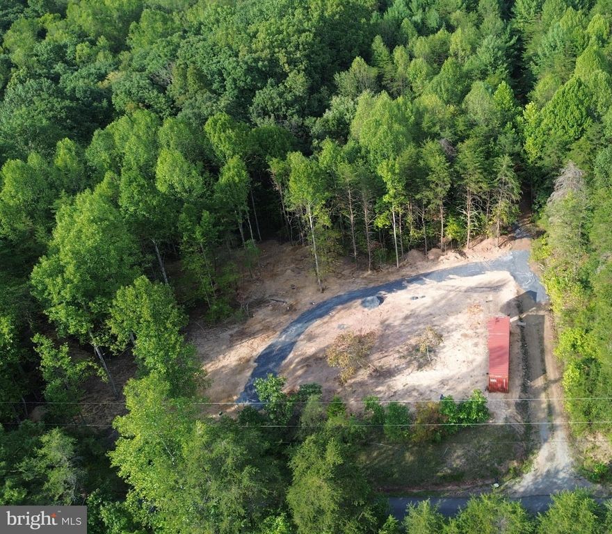 4.85 ACRES - 
•Brand new productive well.
•Brand new live 200-amp electric service. 
•Brand new 3-bedroom septic (easily expandable to 4).
•Half-acre cleared and de-stumped area ready to build home.  
•RV Parking pad with hook ups to water, electric and septic.  
•285 feet of road frontage along a paved and maintained county road. 
•Large red and white oak trees on the lot (can be converted to cash).
•Starlink tested by current owners with great high-speed results (does not convey).
•No HOA. Minimal development covenants.
•500-foot access road to the back of the lot.
•Second perc done on back lot for additional septic if desired (Class I).
•Majority of land flat for building.
•Immediately available to convey, no liens, clear title. Storage container in photos has been removed.

"Respectfully, do not bother the RV or the resident on the lot. Park near the road on the driveway. Do not drive up into or around the lot."