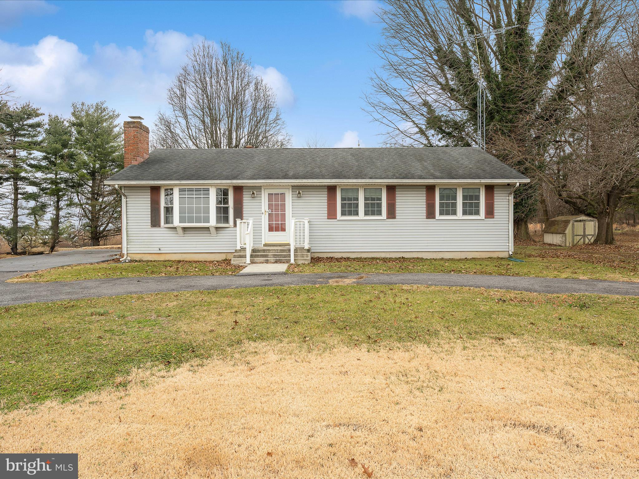 This lovely 3 bedroom 2 bath ranch-style home is sited on a beautiful, level 1 acre lot. Inside the home you enter into the spacious living room with easy-care hardwood floors and a bay window for lots of natural light. Beyond this you have a large dining with a large pantry/storage closet. The glass paned doors afford access to the rear yard and provide great views from your dining table. The dining room opens to the kitchen with easy care vinyl floor, maple cabinetry and laminate counters. You also have a true gem in the porcelain on cast iron double bowl sink. That's becoming a rarity these days. Down the hall you have two generously sized bedrooms with hardwood floors and overhead lighting. The hall bath features vinyl floor, a single bowl sink with medicine cabinet, and a 5 ft porcelain on cast iron tub with tiled surround. The primary suite features lovely hardwood floors and ceiling fan. Your primary bath features a 30 in, single bowl vanity and 3 ft. corner shower with acrylic walls and tempered glass doors. The home sits on a full basement that has been partially finished. The finished space is a huge rec room measuring 13 ft x 32 ft. Here you have a brick fireplace with gas logs and raised hearth. The ceilings are accented by faux wood beams. This is a great space to gather with friends and family. The remaining, unfinished space has been freshly painted and is home to the furnace, water heater, water softener, electric panel, dehumidifier, as well as the washer and dryer. There's also plenty of room for storage. There is an outside entrance to the backyard. The land surrounding the house is lush and level. It's peppered with mature trees for dimension and shade. From the dining room concrete stairs walk down to the large brick patio. This is a great space to host in the warmer months. This home has everything you want and need at a great price. Call for your showing today!