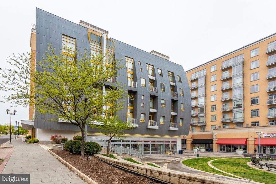 Modern, light filled, rarely available two-level, one bedroom loft with open floor plan.  Like-new. Entry level offers floor to ceiling windows, gourmet kitchen with stainless steel kitchen appliances, granite countertops, center island, hardwood floors and fabulous view of the shops at courtyard from living room on front facing balcony. Second level has stackable, in unit washer dryer, modern design, hardwood floors, large walk-in closet and ample space for an office.  Bath has separate tub and standing stall shower. Secure access building with private, off street unassigned parking in attached garage. Walking distance to metro, shops,  movie theater, Whole Foods, university shuttles. This one won't last!