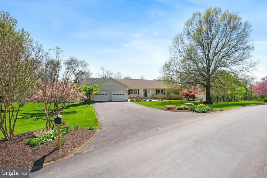 Discover 9500 Holsey Road—unassuming from the street, this home opens to an unexpectedly expansive, beautifully updated interior—truly one you have to see to appreciate. Set on nearly 4 acres, this impressive 6,176 sq ft rancher also offers over 900 sq ft of unfinished space with potential to convert into a rental unit or in-law suite, plus a 1,200 sq ft detached outbuilding/workshop/garage. Outside, enjoy beautifully landscaped grounds accented by mature trees, seasonal blooms, and fruit trees, creating a picturesque, private setting. The main level has been meticulously maintained and thoughtfully renovated, including a substantial addition that created a great room and a second primary suite. Additional highlights include a newer roof (2021), 2-zone HVAC (2018, 2013), sump pump, hardwood floors throughout the main level, a koi pond with a moving water feature for aeration, chicken coop/dog run, garden boxes, beautiful landscaping, and a huge backyard backing to woods. Step inside to an open, light-filled living area with flexible space for both living and dining—ideal for entertaining, with room for an oversized dining table that seats 12+ comfortably. French doors lead to an expansive 18’ x 30’ deck with scenic, private views. The space flows seamlessly into a renovated gourmet kitchen featuring quartz countertops, soft-close white cabinetry with under-cabinet lighting, a deep farmer’s sink, stainless steel appliances, a 6-burner propane cooktop with hood, double wall ovens with microwave and convection options, a distinctive artisan tile backsplash, table space, and a large granite island with breakfast-bar seating. A second set of French doors provides additional access to the deck from the kitchen. One of the home’s standout features - the 1,200 sq ft addition added a great room and a guest suite. The great room has a natural pull that makes you want to gather and stay awhile, with cathedral ceilings, a wet bar, and a fireplace set into a rustic stone accent wall, flanked by oversized windows. The adjacent bedroom suite includes a walk-in closet and a spacious bathroom with warm finishes, including an antique claw-foot soaking tub, a dual vanity, and a large walk-in shower. Wide passageways provide ample space for a walker or wheelchair. Conveniently located between the kitchen and the great room is a mudroom/laundry room/pantry with access from the attached two-car garage. On the opposite wing of the home, you’ll find the spacious primary suite with walk-out access to a private, fenced side garden featuring koi ponds, a hot tub, a new deck, and abundant seasonal blooms. The spa-like en-suite bathroom offers contemporary finishes, a stand-alone soaking tub, an oversized glass-enclosed shower with tile surround, a stylish dual vanity, and a linen closet. The bathroom opens to a huge walk-in closet with natural light and built-in organizers. Two additional bedrooms and a newly renovated hall bathroom complete the main level. The walk-out lower level provides generous flex space with room for a lounge, media room, game room, home gym, and office. It’s finished with resilient LVP flooring, recessed lighting, and a pellet stove. French doors open to the patio and backyard with extensive green space, a firepit, and private wooded views. From the patio, a private entrance leads to over 900 sq ft of unfinished space, offering the possibility of conversion to a rental unit or in-law suite (design attached with the disclosures).  As an added bonus, the 30’ x 40’ detached workshop offers exceptional extra space—ideal for four cars and/or a dedicated workshop for tools and projects, perfect for car enthusiasts or DIY specialists. The property also includes a chicken coop/dog run, garden boxes, a trampoline, a playhouse, and firepit—all convey. This unique property offers an abundance of finished and unfinished spaces, with incredible versatility and potential to suit a wide range of needs.