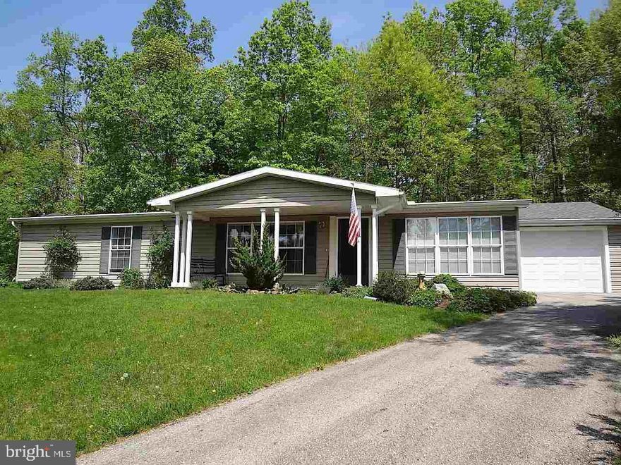 LOVELY RANCH HOME IN 55+ COMMUNITY! Spacious 2 or 3 BR, 2 full BA home backs up to woods for privacy and bird watching galore! Sunroom or Den in front could be 3rd BR. Eat in kitchen PLUS formal dining room! Large LR! 1st floor laundry! Central Air! New Roof! Attached GAR! House sits back off road! Relax in the screened in porch & enjoy nature! Very affordable!!