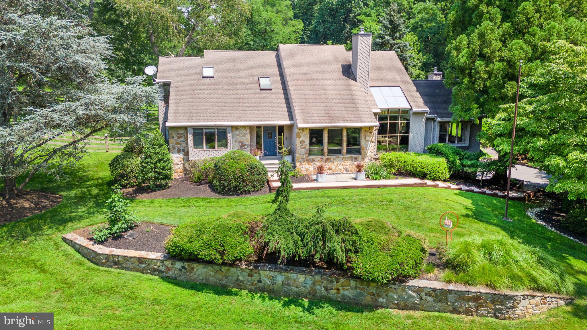 Welcome to "Spring Pond" in West Chester. If you are looking for a special place to call home, you just found it. A long driveway takes you around its pond and creates a striking first impression. Set on beautifully landscaped grounds, it feels like a private retreat, yet its East Bradford location is close to everything. It is nestled on a stunning 1.4-acre lot, with lush greenery. Step inside to discover living space that seamlessly blends style and functionality. Spacious home with large windows flooding the rooms with natural light. Picturesque views out of every window enable you to enjoy the surrounding landscape and tranquil pond from the inside. You enter the home by walking up the new front porch into the Foyer. This Contemporary home features an open-concept with a First-Floor Primary Bedroom Suite that has a walk-in closet, and oversized Bath. First floor also features a Living Room, Dining Room, eat-in Kitchen and Great Room that has an impressive floor to ceiling gas fireplace. The sleek Kitchen (major renovation in 2018) is a chef's delight, equipped with high-end Gaggenau appliances, a sub-zero fridge & freezer and with an abundance of stylish cabinetry for storage. A Half Bath and large Laundry Room (with new Electrolux Washer & Dryer) complete the first floor. The second floor offers 2 additional Bedrooms, a large Loft and a Jack & Jill Bath. The Loft is now used as an office, but it could be turned into a 4th Bedroom, if needed. Just off the Dining Room is a large Screened Porch just perfect for enjoying that morning cup of coffee while you listen to the birds sing. At the end of the day, step outside to your private backyard paradise where you can enjoy al fresco dining on the expansive deck or Patio. Lower level has finished space that would be a great for an exercise room or kids' space and there is a large storage area too. The fenced back yard with raised bed garden offers plenty of space for outdoor activities, making it perfect for families or those who love to entertain. Minutes to Longwood Gardens, the town of West Chester with its quaint shoppes and amazing restaurants. You live in the country but with easy access to major roads, the airport, schools, train, and tax-free shopping in Delaware! Schedule your private tour of this special property today!