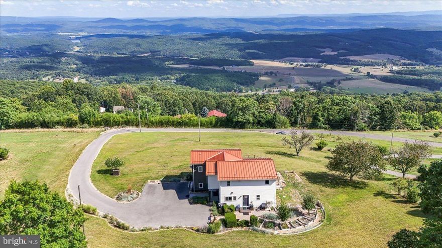 They call it "Almost Heaven" for a reason...find out why at 9475 Waxler Road!  Perched overlooking a wide expanse of the best fields and rolling hills West Virginia has to offer rests this 4 bed / 3.5 bath contemporary beauty. Nestled on over two acres, this property has room for you to stretch your legs and to breathe the mountain air.   The recently added great room expansion has created panoramic views of the entire valley below--enjoy from inside or outside from decks on both levels!  Frankly there are too many updates, bonuses, and highlights of this house for words to do justice.. you just have to come and see it!