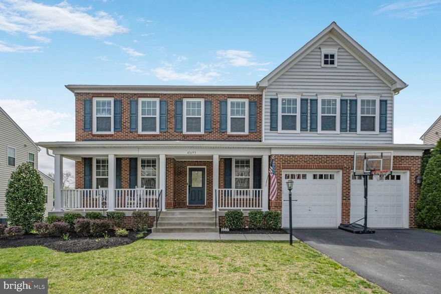 Step into this beautifully crafted brick-front home nestled on a cul-de-sac in the desirable Marrwood section of Stone Ridge, and you will feel right at HOME. A charming front porch welcomes you into a dramatic two-story foyer, highlighted by a grand iron-railed staircase and gleaming hardwood floors that span the entire main level.

Entertain with ease in the formal dining room, which flows into a kitchen made for gathering to share meals and memories. This gourmet space boasts an oversized island, stainless steel appliances, upgraded cabinetry, double wall ovens, under-cabinet lighting, and a large walk-in pantry. The kitchen opens to a spacious family room centered around a striking stacked-stone gas fireplace. The main level also includes a full bedroom and full bath—ideal for guests, multi-generational living, or an office—as well as a convenient mudroom off the garage to keep clutter tucked away.

Upstairs, a bright loft space connects four generously sized bedrooms. The luxurious primary suite features a tray ceiling, spa-like bathroom with dual vanities, soaking tub, separate shower, private water closet—and two expansive walk-in closet spaces. Two additional bedrooms also offer large walk-in closets, and all three secondary bedrooms share a well-appointed hall bath with a separate tub/toilet area. The modern upper-level laundry room adds convenience and the perfect finishing touch.

The finished lower level provides a flexible open space ready for your vision—whether it's a media room, playroom, or hang out spot. A sixth legal bedroom, full bathroom, home gym, and unfinished storage space complete the walk-up basement area. Step outside to your private backyard retreat with a low-maintenance composite deck, stone patio, and a play set that conveys. All that and a brand new roof too (2024)! Enjoy all the incredible Stone Ridge amenities, including multiple community pools, clubhouse, fitness center, meeting rooms, and more. Don’t miss the opportunity to make this exceptional home yours!