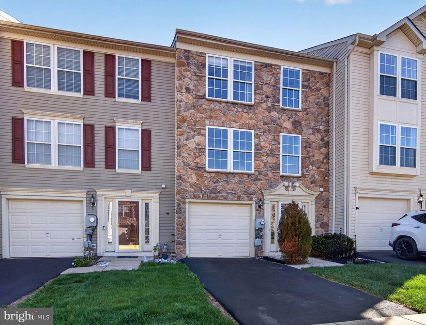 Welcome to this 3-bedroom, 2.5-bath townhome in Beaver Run Village, fully refreshed and move-in ready with fresh paint, new carpet, updated LVP flooring, and stainless steel appliances. The entry opens to a foyer that leads into an oversized lower-level living space with a convenient half bath, ideal for a second living area, office, or entertaining. This level also includes laundry and direct access to the garage. Upstairs, the main living area offers a spacious layout with a well-sized kitchen featuring an island and stainless steel appliances. A bright dining area with multiple windows brings in strong natural light, while a large living room completes the level. The primary suite features cathedral ceilings, a large walk-in closet, and a private full bath with a soaking tub and separate shower. Two additional bedrooms and a full hall bath complete the upper level, along with attic storage. Outside, enjoy a large private deck along with a lower patio, offering functional outdoor space for everyday use or hosting. Convenient location with quick access to Route 309 and the Turnpike, plus close proximity to parks, shopping, and the local farmers market. Move-in ready, clean, and easy to maintain!