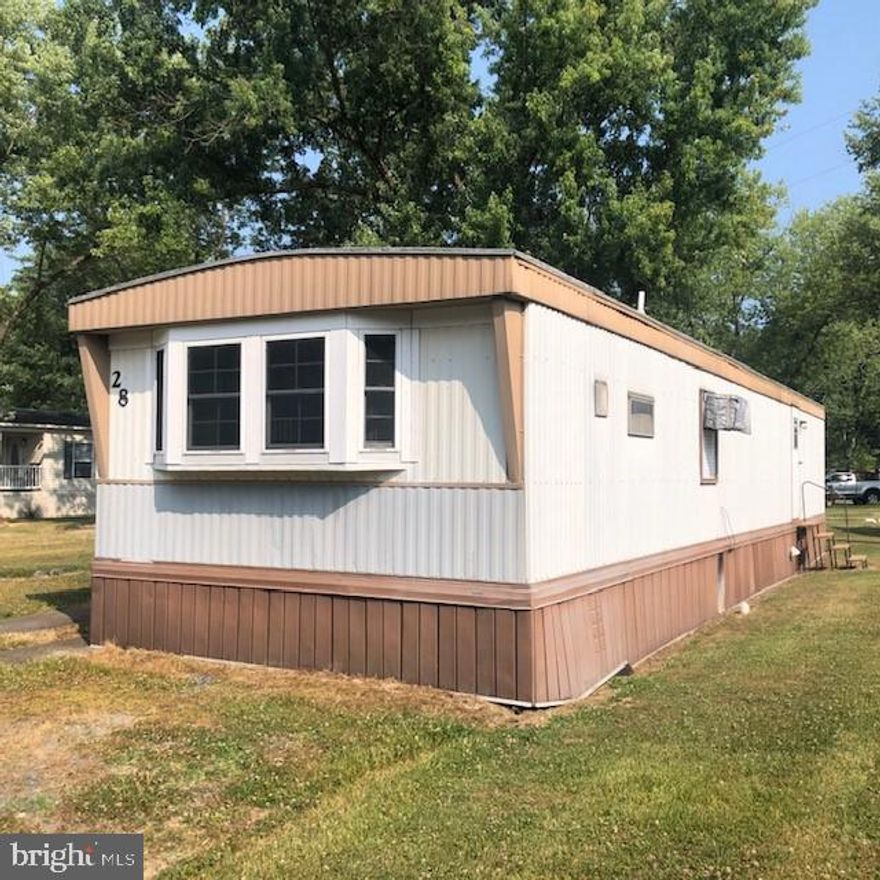 This home is an As Is.  It has been inspected and has been appraised.  It might be perfect for a buyer who would like to make it their home;  most of what needs to be done is cosmetic. It has been inspected when appraised.  It is located in a community for 55+,  about two miles from Route 301, between Waldorf and Brandywine, Md.   The last two pictures are the 2nd bedroom, where some of the rehab has been left.  A  10X7 Shed comes with the house.  There is a small deck for the entry to  the Front Door.   Application for Living in the Community can be
received at the community's office that is open Monday thru Friday from 9-5 except Wednesday 10-7.