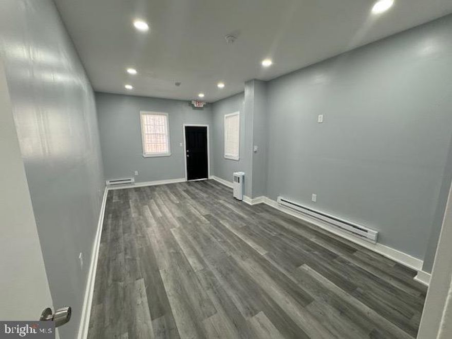 This newly updated office or retail space is ideally situated just south of Washington Ave in the thriving Point Breeze section of Philadelphia. It boasts excellent access to public transportation, including the Subway/Broad St. Line and several bus routes, with a bus stop conveniently located at the corner.  Plenty of street parking readily accessible.
Nearby amenities include a variety of vendors, restaurants, coffee shops, stores, and parking garages. The freshly painted interior features two large rooms suitable for offices or conference rooms, along with plenty of room for a waiting area.  Additionally, the unit includes a clean basement ideal for storage or filing, as well as a large rear patio.
There is also a 1 Bed, 1 Bath 721 sq ft residential apartment above this commercial space listed at $1299/month.  Perfect for a business owner that prefers an easy commute!