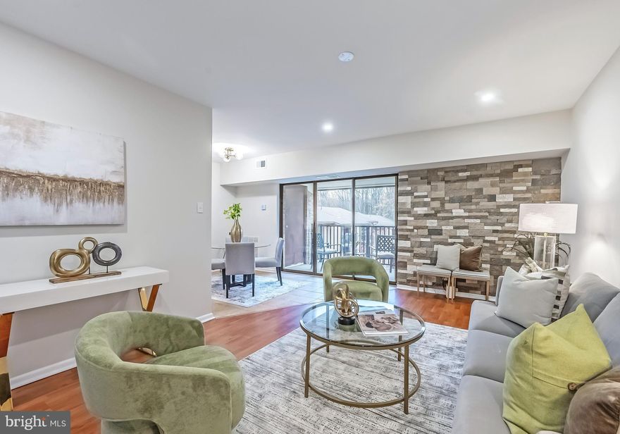 Stylish, Updated Condo in the Heart of Reston!  Welcome home to this beautifully updated 3 bedroom, 2 bath condo perfectly nestled among Reston’s parks, woods, and miles of scenic trails. Light, airy, and move-in ready, this spacious unit offers serene, wooded views and thoughtful upgrades throughout. The inviting living room features a striking stone accent wall and flows seamlessly into the dining area with access to a private balcony, the perfect place to enjoy your morning coffee or unwind with an evening cocktail. The stylish kitchen has been refreshed with brand-new quartz countertops, stainless steel appliances, and generous cabinet space, making meal prep both beautiful and functional. Both bathrooms include modern tile and glass-enclosed showers (one with a tub), and the entire home features low-maintenance LVP and tile flooring. Additional updates include HVAC (2025), Microwave (2025), Washer & Dryer (2022), Refrigerator (2021), and Range (2021). Fresh paint and new lighting complete this turnkey home. You will also enjoy a reserved parking space directly in front of the building (#408) and one guest pass. The condo fee covers all utilities and includes access to Reston Association amenities including outdoor swimming pools, extensive biking and hiking trails, sports courts, and athletic fields. Located just minutes from the South Lakes Shopping Center, Reston Town Center, the Silver Line Metro, the Toll Road, and Dulles Airport, this home offers unmatched accessibility.  Enjoy the best of Reston living with comfort, convenience, and community all in one beautifully updated home!