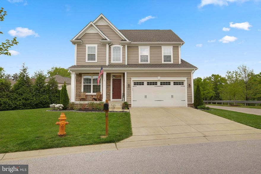 3 years young! This custom-built home by the original owner has it all! Upon entry, you will be greeted by beautiful 3/4" Oak hardwoods throughout the main level. Prepare gourmet meals in the kitchen boasting 42-inch white cabinetry, an expansive center island with a breakfast bar, quartz countertops, stainless steel appliances, and a walk-in pantry. Off the kitchen, you will find a light-filled morning room and a cozy family room with a custom stone fireplace. The spacious master bedroom features tray ceilings, a walk-in closet, an en-suite bath with double vanity, and an oversized frameless glass shower. Three additional generously sized bedrooms and a full bath conclude the upper level. Another large bedroom, a full bath, and a wet bar can be found in this fully finished basement made for entertaining! Enjoy sunny days on the back deck and paver brick patio!