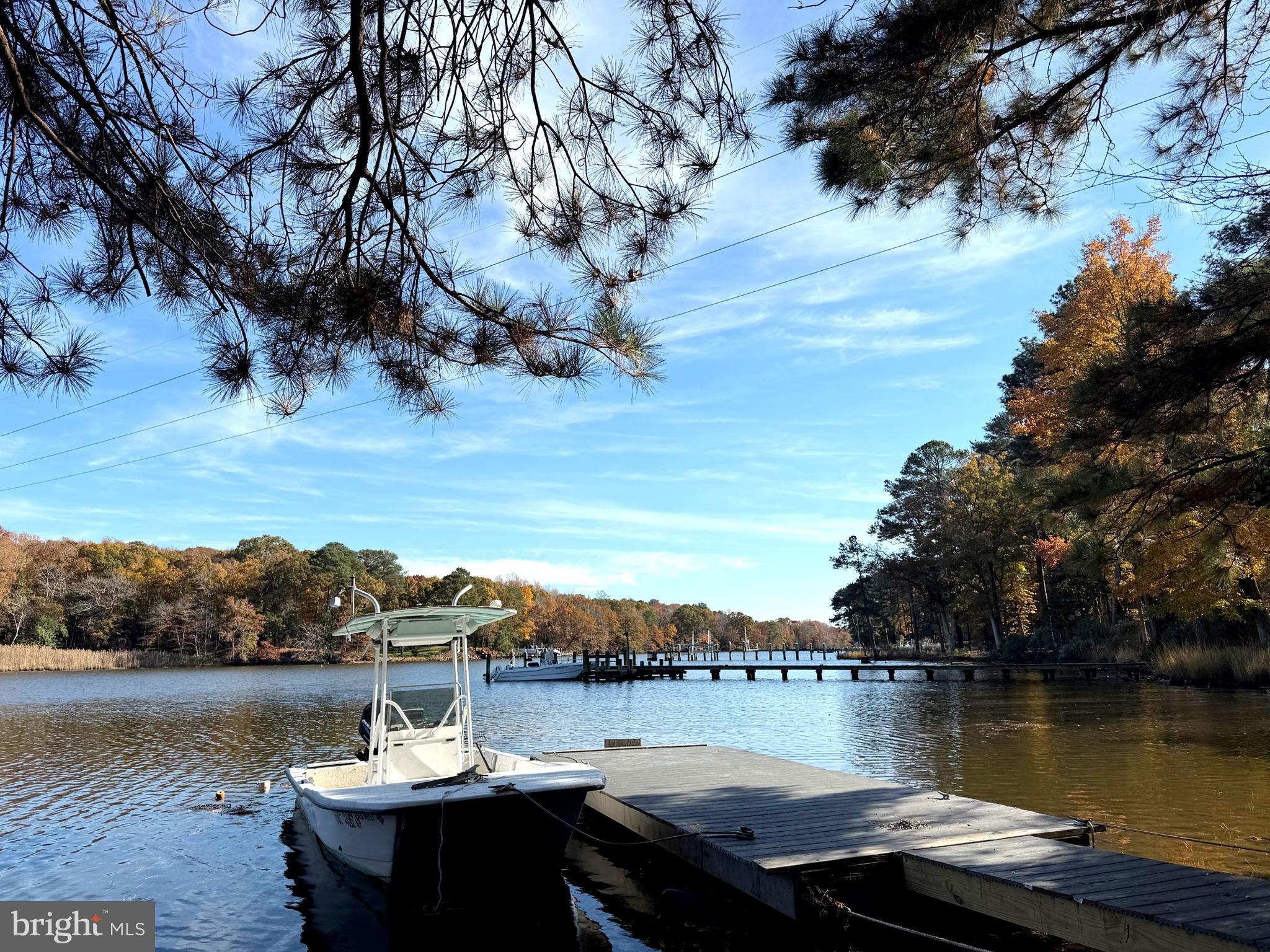 This 1.38-acre buildable waterfront lot, located just outside Ocean City, MD, offers a partially wooded area with a small creek and access to the St. Martins River. The lot is suited for well and septic, with a building envelope of 1,596 sq. ft. confirmed by the county. Enjoy water views of Bishopville Prong and a shared easement for water access and a possible shared pier.. Just 15 minutes from the beach, boardwalk, restaurants, and attractions of Ocean City. The property features mature hardwood trees, an open yard, and a trail around the creek leading to a 15' wide easement to the St. Martins River, which connects to the Assawoman Bay and the Atlantic Ocean. Best buy for a lot over an acre with water access and views!