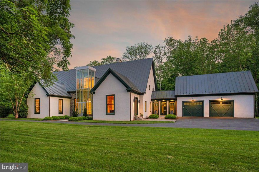 Welcome to ARIVA DWELL,  a true masterpiece of modern design and green living in the heart of Solebury Township, Bucks County.   This Philippe Starck-inspired estate seamlessly blends taste, modern flair, and sustainability, offering a near-zero carbon footprint home that exudes understated quality, detail and elegance at every turn.   Custom builder Ed Stevenson and passive home architect Shannon Pendleton have crafted a visionary residence that elegantly pairs eco conscience luxury with sophisticated innovation.
Set on 2.6 acres of canal-accessible, wooded, park-like property, this unique estate features an integrated multiple-well geothermal system that loops underground for over a mile, providing exceptional energy cost savings year-round.   The gourmet Siematic kitchen, designed and installed by a team from Hamburg, Germany, is a chef's paradise . Boasting a six-burner Wolf range with an indoor grill, Sub-Zero Pro 48 glass door fridge, two Miele dishwashers, a Wolf warming drawer, and a stunning Franke hood. Strategically located alcove cafe offers barista drink options complete with dual-port Miele coffee machines, sink,and an under counter SubZero refrigerator.   Geothermal hot water radiant heated floors ensure soothing warmth and comfort throughout the home when called upon. Recycled concrete poured floor tiles and FSC formaldehyde free, bamboo and Brazilian hardwood enhance the eco-friendly non toxic living environment. The state-of-the-art water system features all Toto fixtures and a salt and chlorine-free whole-home filter that delivers the best ever crystal clean water to every fixture in the house.  An in wall Vacuum system with kitchen floor level sweep openings along with the intercom system are part of the story as well.  The main floor boosts two en-suites ! The primary offers magical park views accented by the Victoria Albert oval soaking tub. Enjoy the open walk-in rainfall shower, poured concrete vanity with two Toto sinks, a large dressing area, additional closets and a small coffee bar for your added convenience.
The second main floor suite includes a cozy lounge, king size bedroom, and complimentary to the kitchen Siematic cabinetry with SubZero wine storage, refrigeration drawers , ice maker and sink .
The real wood burning, gas assist, highly efficient ‘Rumford’ fireplace is one of three in the home. An exterior door as well provides private access to the blue stone outdoor patio.  The second level you will find Jack & Jill suites with tray ceilings, a shared full bath with walk-in stone shower, jacuzzi soaking air bath tub and dual vanities.  There is also a powder room and a full laundry room with another under counter subzero refrigerator which comes in quite handy for the third floor lounge.
The lounge on the third floor is an additional space to gather. The glass tower offers a fabulous place to sit surrounded by glass so you may truly absorb nature in all seasons .   Beyond the upper level lounge is another very private large king size suite with a wonderful living room space and full bathroom.  The private staircase takes you down to the first floor, laundry room off of the mudroom entrance adjacent to tue two car plus extra-large garage with dual car EV charger outlets, and ‘epoxy finished’ floors, a tool storage wall system and well lit handyman work area.  Under the custom lifetime-guaranteed green steel roof, are non-toxic no VOC paints and stains that create a neutral backdrop with large wall space for art to hang.
LED lighting, non-toxic seaweed based spray foam insulation, and a minimalist, sustainable landscaping further elevate the home's commitment to integrity and design excellence.
As the sun sets, low-energy lighting illuminates the stunning 34-foot glass tower, providing natural temperature control and a captivating visual centerpiece.  A 20 KW USA made Cummings house generator ensures uninterrupted comfort and security. #geothermal