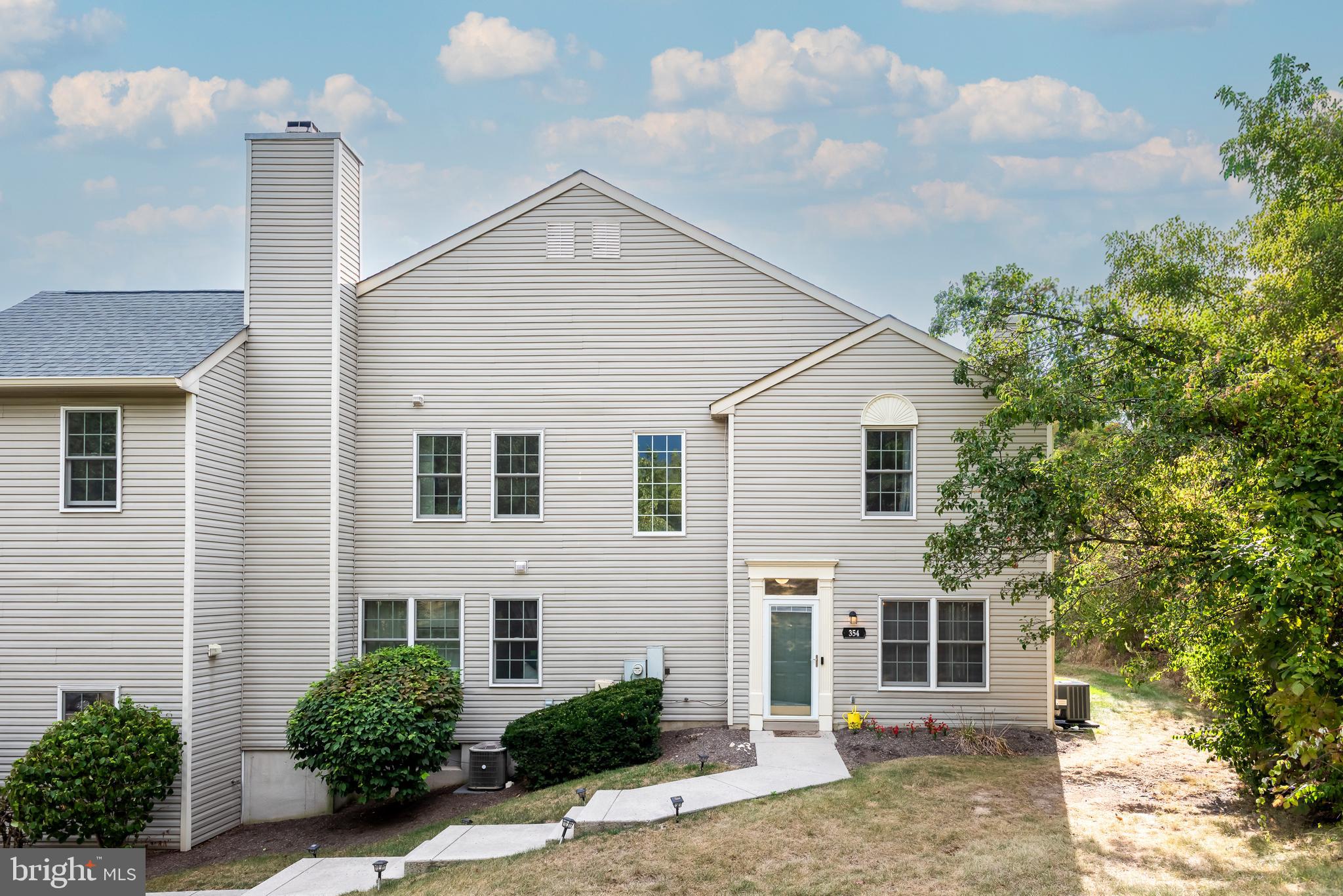 Welcome to 354 Bluestone Court, a charming townhome in the highly desirable Providence View community, perfectly situated in a serene, wooded setting with plenty of parking. This 2-bedroom, 2.5-bath home is move-in ready and reflects true pride of ownership. The sun-filled living room features a cozy gas fireplace and flows seamlessly to the dining area, which opens via sliding doors to a private patio—the ideal spot for entertaining, relaxing, grilling, and dining al fresco. The fully equipped eat-in kitchen boasts oak cabinetry, tile backsplash, gas cooking, and convenient first-floor laundry access. A turned staircase leads to the second floor. Upstairs, the owner’s suite features a vaulted ceiling with a ceiling fan, a spacious walk-in closet, and a private bath. The second bedroom, also with a ceiling fan, has access to the hall bath and is perfect for guests or a home office. Both bathrooms and the powder room have been nicely updated. Enjoy all that Providence View has to offer, including a clubhouse and pool. Ideally located just minutes from major routes, top schools, the shops and restaurants of Collegeville, and the booming downtown Phoenixville. This is a great home in a prime location. Your search is over—welcome home!
