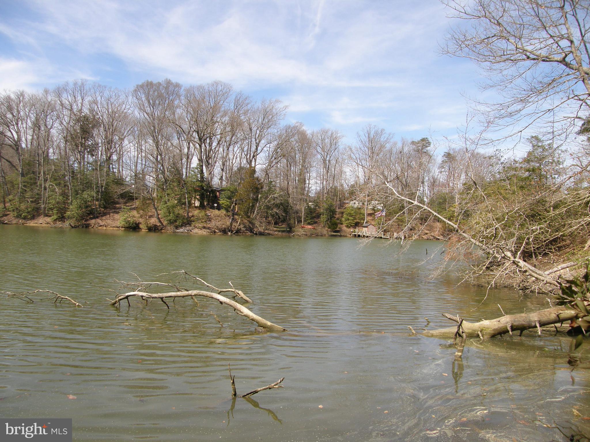 Check the inventory for buildable waterfront lots with recorded perc off the Patuxent! There are NONE except this one. Why buy and older house for over $600K tear it down and spend a ton to rebuild??? Buy this lot and build your dream home. Actual lot size is to 2.69 acres (with 216 ft of sheltered shoreline) not 2.75. GREAT DEAL ON REAL BUILDABLE WATERFRONT LOT! No Marshland....NO APPOINTMENT NEEDED- Go and Show! Deep sheltered waterfront just off the Patuxent River. Minutes to Solomon's and the Chesapeake Bay. Best priced buildable waterfront lot in St Mary's County with real waterfront for a boat and close to everything- Base, shopping, fishing, boating on Patuxent/Chesapeake Bay, and restaurants on the water!!!!! If you are a serious waterfront buyer you know what's on the market and you will agree this is a great deal!!!! (If you want sheltered deep water just off Patuxent close to Solomon' s and Sheltered ski creeks/raft up creeks and awesome fishing) Pier permit in hand! Check out aerial photos of lot and creek.
NO APPT Required to show. Vacant lot.