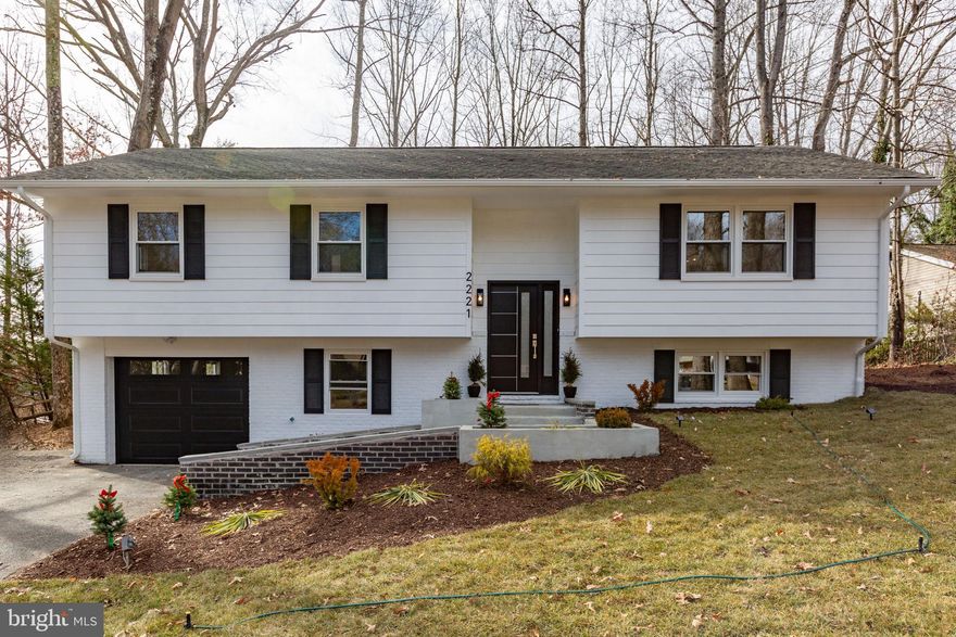 Welcome to a rare, design-forward renovation in one of Stafford County’s most sought-after waterfront communities. Located at 2221 Harpoon Drive inside Aquia Harbour, this completely remodeled home delivers a level of style, finish quality, and modern craftsmanship that truly stands apart. Every detail has been thoughtfully curated — from the materials selected to the flow of the spaces — creating a home that feels both elevated and effortlessly livable. The exterior sets the tone with a crisp white façade, black shutters and matching front door, new windows, updated roof and polished curb appeal. Inside, the transformation is immediately evident. A bright, open-concept main level is anchored by a stunning new kitchen featuring quartz countertops, a dramatic waterfall island, new cabinetry, and brand new appliances — a true centerpiece designed for both entertaining and everyday living. The kitchen opens seamlessly into the living and dining areas, highlighted by a sleek, modern fireplace that adds architectural interest and warmth. Sliding doors lead to the 12x14 deck and fenced backyard, extending the living space outdoors. The primary suite continues the high-end design story with a spa-inspired bathroom showcasing marble flooring, a beautifully tiled ceramic shower, and refined finishes rarely found at this price point. All bathrooms throughout the home feature porcelain tile wall finishes, elevating the overall look and durability while maintaining a cohesive, luxury feel. Three bedrooms and two full baths complete the upper level. Downstairs, the fully finished lower level offers exceptional flexibility with a large family room, an additional bedroom or office, a third full bath, and a dedicated laundry area — perfect for guests, multi-generational living, or work-from-home needs. New LVP flooring flows throughout the home, complemented by updated electrical, plumbing, HVAC, and water heater systems — providing both style and peace of mind. Outside, mature trees, a firepit seating area, covered deck, and a storage shed create a private, relaxing backyard retreat. Located within gated Aquia Harbour, residents enjoy resort-style amenities including a marina, golf course, pools, tennis and pickleball courts, trails, playgrounds, and equestrian facilities. Conveniently positioned just minutes from Garrisonville Road shopping and dining, I-95, Quantico and the VRE, and less than 30 minutes to downtown Fredericksburg. For buyers seeking a turnkey home with standout design, premium materials, and a lifestyle-rich location — this one delivers on every level.