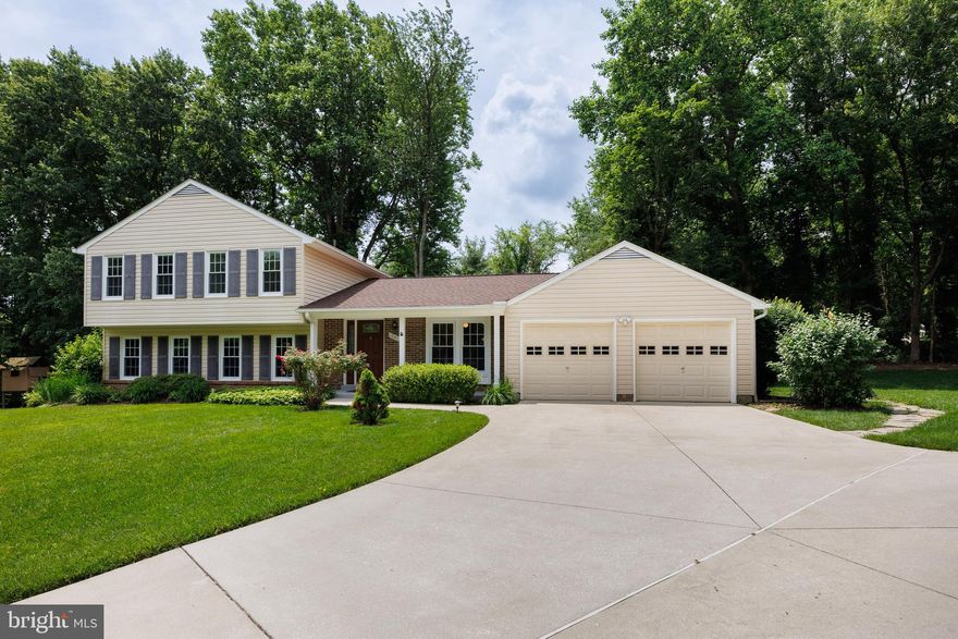 OFFER DEADLINE - MONDAY, JUNE 16TH AT 2PM. Welcome to this well maintained 4-level split home, nestled in a desirable neighborhood at the end of a peaceful cul-de-sac. This charming home offers 4 spacious bedrooms and 3 full baths, making it perfect for growing families or those who enjoy hosting guests. As you enter, you’ll immediately notice the spacious foyer and laminate plank flooring that flows throughout the main level. The formal living room & dining rooms offer a great space for your more intimate gatherings, while the eat-in kitchen provides direct access to the garage for convenience. Just off the dining room, step outside to a screened-in porch with a cathedral ceiling — a perfect spot to relax or entertain while enjoying some fresh air and natural surroundings. The upper level boasts a primary bedroom with a walk-in closet, an additional separate closet, and your own private full bath with separate make-up vanity area. Two additional bedrooms share a hall full bath with jetted tub, completing the upper floor. The lower level is ideal for family gatherings, featuring a large family room with a cozy wood-burning fireplace.  Adjacent to the family room is the fourth bedroom, a full bath with a shower, and a laundry room equipped with built-ins and easy access to the backyard. Go down just a few more steps to the 4th level, where you'll find a rec room and two additional finished rooms with new  carpeting plus an entire wall of closets for great storage. The exterior boasts a welcoming front porch, slate walkway to backyard, back screened-in porch, deck, slate patio and backs to community space. Parking is easy with a 2-car attached garage and spacious driveway. Fantastic location - convenient to shopping, restaurants, medical, schools, parks, pools and commuter routes! Some updates include - Roof, 2019, Updated insulation 2013 and then garage in 2024; updated windows in 2007 and basement windows in 2024, new fridge in 2024. This spacious house combines practicality, privacy, and flexibility, making it a great choice for some updates and personal touches to make it your own!