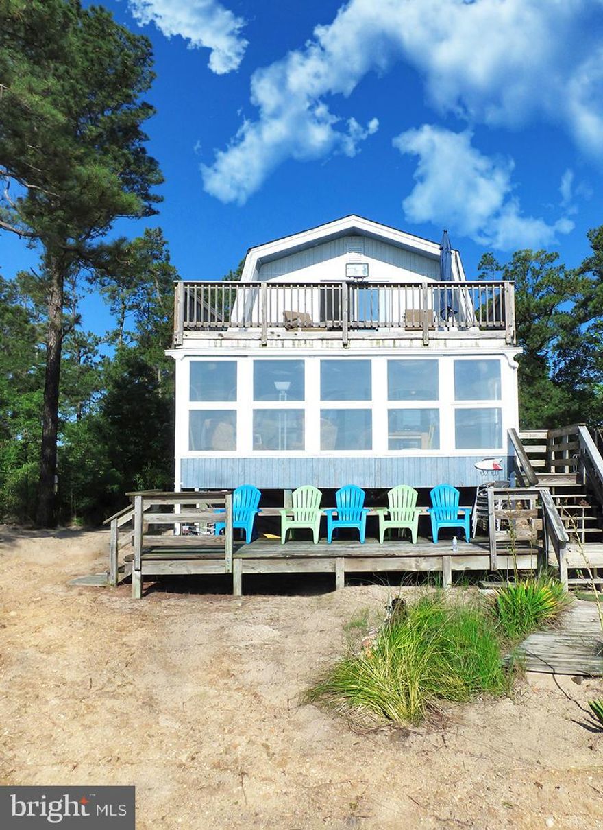 Only still available because it is a vacation rental and can not often be shown! Featuring spacious glass enclosed all season porch, double decks, & more. Hear the waves while you cook, read or relax. Like bird watching? Here you will see bald eagles, swans, herons & ospreys to name a few. Party shed included with this double beach front lot! This spectacular home can only be shown by appointment!