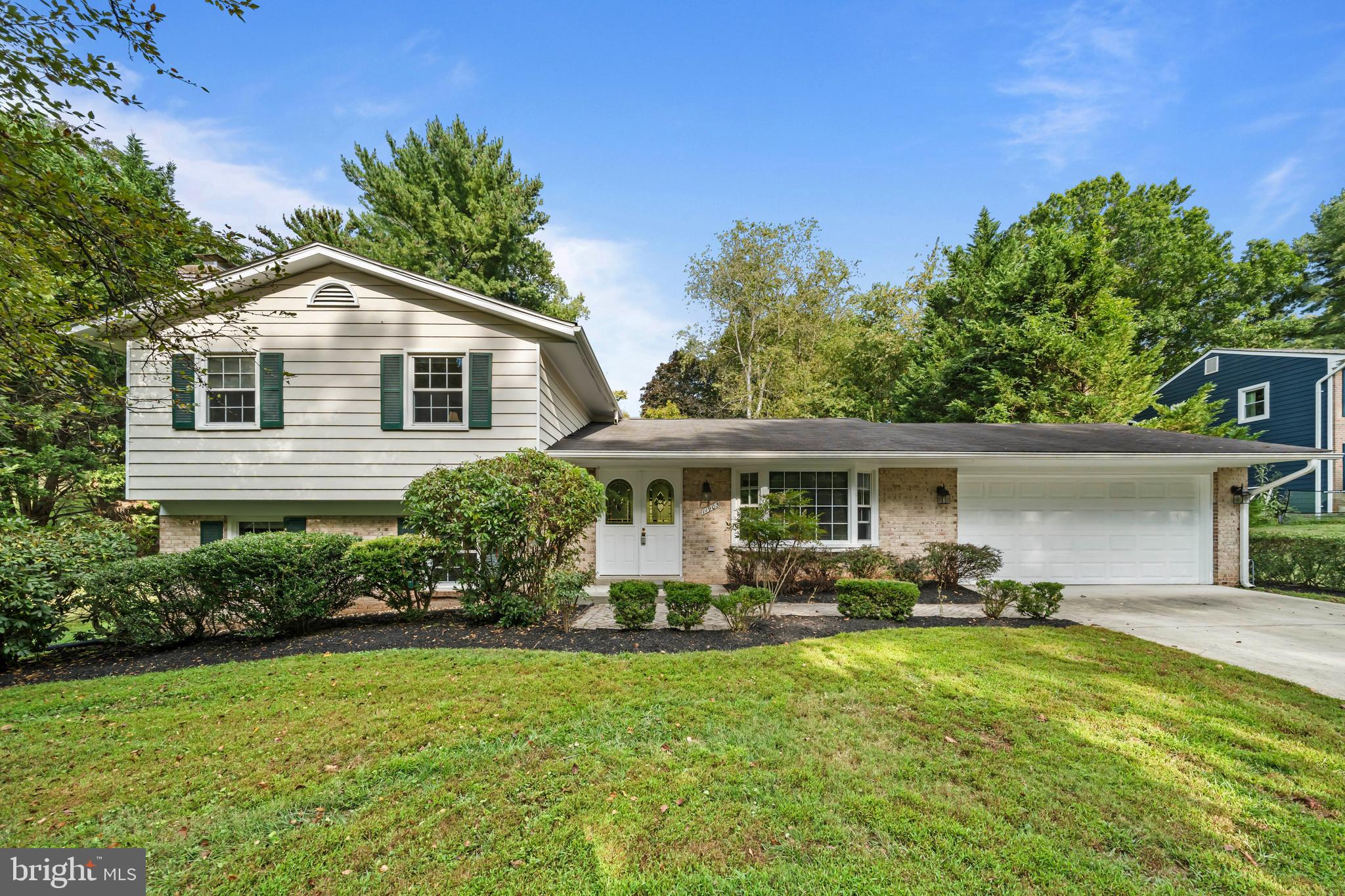 Welcome to this gorgeous light-filled home that is move-in ready! If you are looking for more space, a nice community, and excellent schools, look no further! Notice the FLAT and EXPANSIVE SIDE YARD! The main level has a welcoming foyer, a living room that opens to a dining space overlooking the patio and private backyard. The kitchen features updated cabinets, granite countertops, and stainless steel appliances. A bay window brings in views of the front lawn and trees and, hosts a breakfast nook. The upper level has 4 spacious bedrooms and 2 full baths. The finished lower level highlights a family room with a fireplace as well as a bedroom, a half bath, and a utility/laundry room. The walkout basement has access to the side of the house with a vegetable garden. The house has a wonderfully serene setting and is located on a quiet street. This sun-drenched home features hardwood floors on the main and upper level and porcelain tile in the lower level. There are a two-car garage and a large driveway for additional parking as well as ample street parking for entertaining. Enjoy working from home, hosting at home, and easy access to commuting routes, shops, restaurants, parks, trails, and excellent schools. Mortgage savings may be available for buyers of this listing.