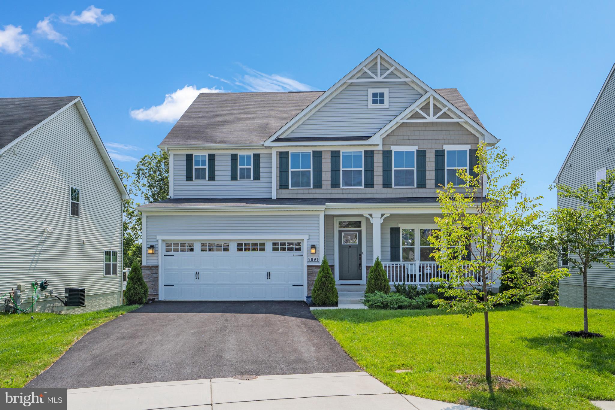 OFFER DEADLINE is 12pm, Monday, July 31st. Welcome to your dream home! Built in 2020 and gently lived in, this magnificent porch front home offers a perfect blend of contemporary design and natural beauty. Located on a peaceful cul-de-sac with a Yoshino cherry tree in the front yard, this home boasts a range of highly desirable features that will delight every homebuyer. Step inside to this bright and spacious home with open concept living space that seamlessly connects the heart of the home in the living room with gas fireplace, open dining area, and gourmet kitchen featuring stainless steel appliances, quartz countertops, gleaming custom backsplash, gas cooking stove and range, and a wall oven and microwave. The long entertainer's island is ideal for social gatherings and culinary creativity. A bonus room can be found down the hall and is a great space for a den or office. Also on the main level is a half bath, and off the kitchen leading to the 2 car garage with epoxy floors is a mud room. Upstairs the Primary’s Suite is a true sanctuary with a geometric tray ceiling, 2 walk-in closets, and an ensuite upgraded bathroom with modern fixtures, dual vanities, large glass shower with 2 shower heads and bench. Down the hall there are 3 more bedrooms, a large hallway bathroom with dual vanities, a loft area offering ample space for a second living room or family room, and a laundry room with a pine butcher block over the washer and dryer and overhead cabinets. On the lower level is an unfinished basement that you can make into your own space, with rough-ins for an additional bathroom. Enjoy relaxing and hosting friends and family this summer on your covered trex deck off the living area providing a serene escape overlooking a private tree-lined backyard. Embrace the joys of living in a neighborhood located in the Howard County school district, close to parks, dining, shopping, and easy access to commuter routes. Whether you are headed to Baltimore, D.C., or Northern Virginia, this central location is ideal. Don't miss out on this exceptional opportunity to own your dream home. Schedule a showing today and experience the beauty and functionality of this remarkable property. Your dream lifestyle awaits!