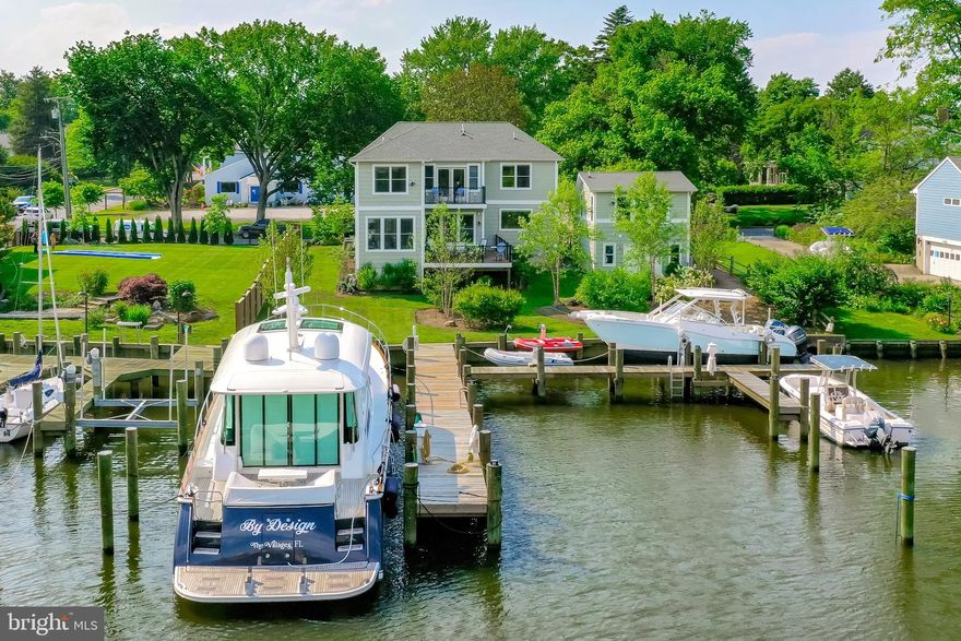 A boater's delight in the heart of Eastport! This incredible 2018 Craftsman style home in Eastport offers 79 feet of water frontage, new, raised bulkhead (2021) and completely reconfigured FIVE SLIP, 70-foot, deep water pier by Dan Lerian (2021) on protected Back Creek. Situated on .23 flat acres, you're just steps away from your pier with endless activities on the water. The pier has held a 44ft sailboat and 66 ft Sabre comfortably. The spacious eat-in kitchen and open floor plan on the main level with two living rooms and easy access to the rear deck allow for seamless entertaining and views from almost every room. To complete the main level, the room just off of the foyer can be used as an office, music room, or playroom. The configuration of this home can work for families of many sizes. With 3 to 4 bedrooms upstairs, a complete 2-level au pair or in-law suite above the detached garage with a separate entrance, and a fully finished lower level with walk out to the waterfront, the options are numerous. The owner's suite on the upper level offers views from the bedroom with balcony as well as the stunning primary bath and office. This home has achieved spacious yet cozy throughout. Tax records are incorrect, the home offers 3200 square feet above grade. 

Walk to everything Eastport has to offer! Enjoy the live music at the non-political Eastport Democratic Club, swim or play tennis at Safe Harbour Marina, stroll to the many pubs and restaurants like Davis' Pub, Forward Brewing, Boatyard, Baker's & Co. and many more. Welcome Home!