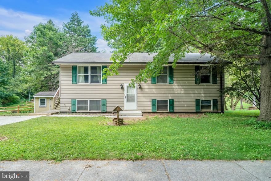 This charming split foyer home in the desirable Breezewood-Morelock community offers a perfect blend of comfort and functionality. With 3 spacious bedrooms and 2.5 bathrooms, the inviting layout features an eat-in kitchen equipped with essential appliances, making meal prep a delight. Large upstairs living room has gorgeous vaulted ceilings or Cozy up by the wood-burning stove in the basement, or enjoy the convenience of a full basement with a walkout entrance. Set on a lovely 0.18-acre lot, the property boasts serene views of a nearby Deer Creek, providing a peaceful backdrop for outdoor relaxation. Experience the warmth and comfort of this delightful residence, where every detail invites you to create lasting memories.