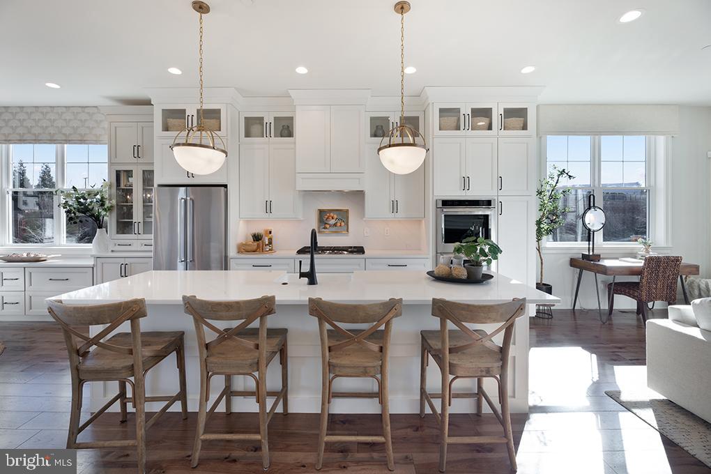 Step into the embrace of this enchanting 3-bedroom, 3.5-bathroom end unit townhome, poised for completion and eagerly awaiting your arrival in end of summer 2024. This year, treat yourself to an extraordinary gift – a pristine, low-maintenance haven bathed in natural light.
Nestled within the vibrant community of The Towns at Newtown Walk, this end unit home gleams like a precious gem, boasting an exceptional floor plan adored by our residents. Upon entry into the foyer on the first level, you'll be enveloped in the space's radiant charm. Designed for your convenience, this level features a handy coat closet, a flexible guest bedroom or office space, and a full bathroom. The rear 2-car garage and spacious 2-car driveway offer ample parking and convenient access.
Ascending to the primary living level, prepare to be enchanted by the natural light cascading through numerous windows, accentuating the already lofty 10-foot ceilings and the expansive layout. The kitchen, aglow with sunlight, commands attention with its 42" soft-close cabinets, gleaming quartz countertops, a magnificent island, stainless steel appliances, and dazzling hardwood floors. Hosting guests becomes a delight in the luminous dining area, while relaxation beckons in the spacious living area, complete with a cozy gas fireplace.
The sun-drenched primary bedroom easily accommodates a king-sized bed, dresser, and nightstands, with generous space in the expansive walk-in closet for your wardrobe and shoe collection. Unwind in the ensuite bathroom, where natural light dances upon the walk-in shower with a bench, the private water closet, and the double vanity.
A hallway with laundry facilities leads to a second large bedroom with an ensuite bath. However, the true treasure of this remarkable home awaits – the rooftop terrace, surrounded by windows that bathe the space in radiant light. Imagine savoring your morning coffee as the sun rises or enjoying al fresco dinners with loved ones. This space even allows for planter gardening and the potential for a fireplace or BBQ area.
Being an end unit, this townhome is adorned with extra windows, ensuring an abundance of natural light from every angle. The Towns at Newtown Walk offers a final opportunity to join the thriving Ellis Preserve community. With easy access to major roadways, the airport, the train station, and Routes 252 and 3, your daily commute is effortless.
Please note that actual home finishes may vary, as this home is currently under construction. Don't miss the chance to claim this exceptional, well-lit, and contemporary 3-bedroom, 3.5-bathroom townhome as your new sanctuary!