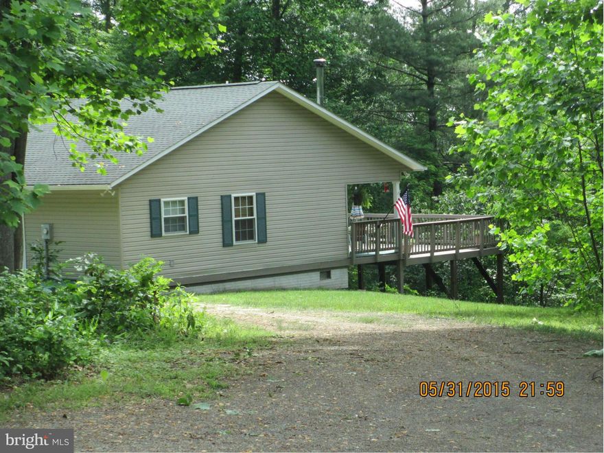 Surround yourself with nature! Adorable rancher secluded on 20.05 mostly wooded acres just 17 miles from Winchester off route 50. Freshly painted, shows like new. Home features woodstove, huge back deck perfect for quiet evenings or entertaining. Large 1120 sq ft detached garage with 200 AMP electric service. Suited for second home or year round living,