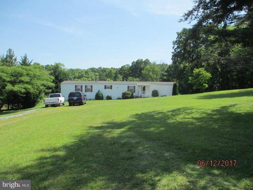 Well maintained 1,216 sq ft mobile home on 2.5 acres . Conventional septic . No HOA. Spacious Master Bed/Bath.  Located just minutes off Route 50. Close to schools and shopping.  Enjoy quiet times on back covered deck. Backs to woods for privacy. Lovely clear and wooded lot. Must see to appreciate.