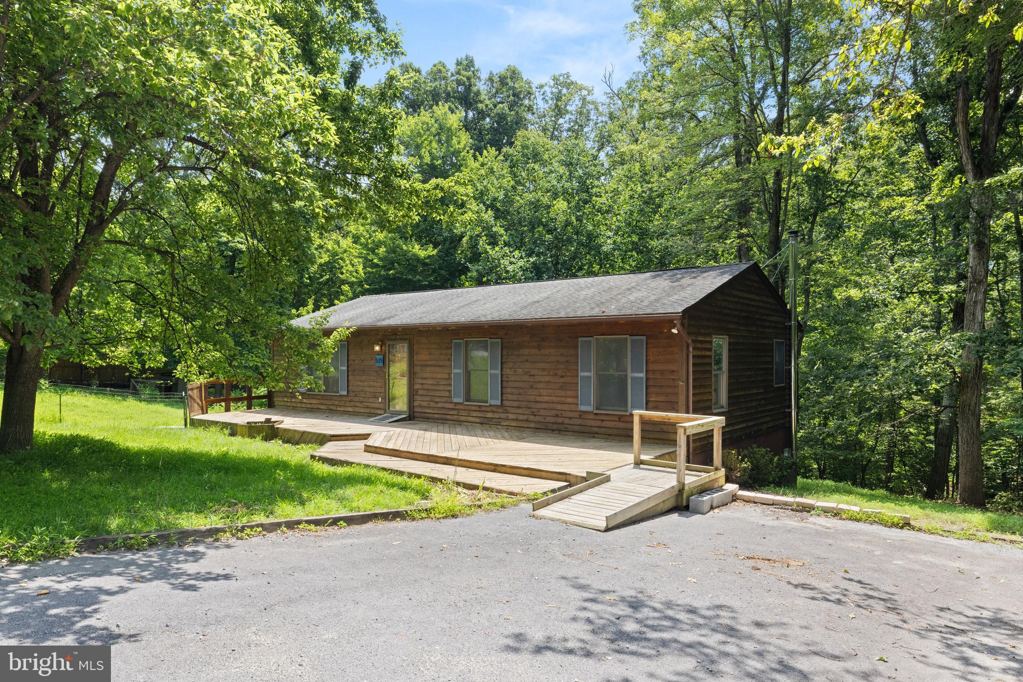 *** OPEN HOUSE SATURDAY JULY 19th FROM 11-1 pm **** Find the peace and serenity you’ve been looking for at 525 Main Drag Way, Harpers Ferry WV. Tucked back on a quiet road this house is the perfect place for peaceful living. Upon entering the home you will find LVP flooring and natural light throughout the main living area - large family room on your left and just beyond that is the dining room and kitchen. Down the hall you have a full hall bath and 3 bedrooms with brand new carpet. The master has an in suite bathroom with a walk in shower. Off the back of the house is a wonderful deck, giving you a great place to unwind after a long day.
The walk out basement features its own bedroom, full bath, and living room complete with a bar area and woodstove for those chilly winter nights. The basement also offers lots of storage space. High speed Internet. Quiet, yet convenient location to VA and MD, amenities, recreation, entertainment, and so much more!
