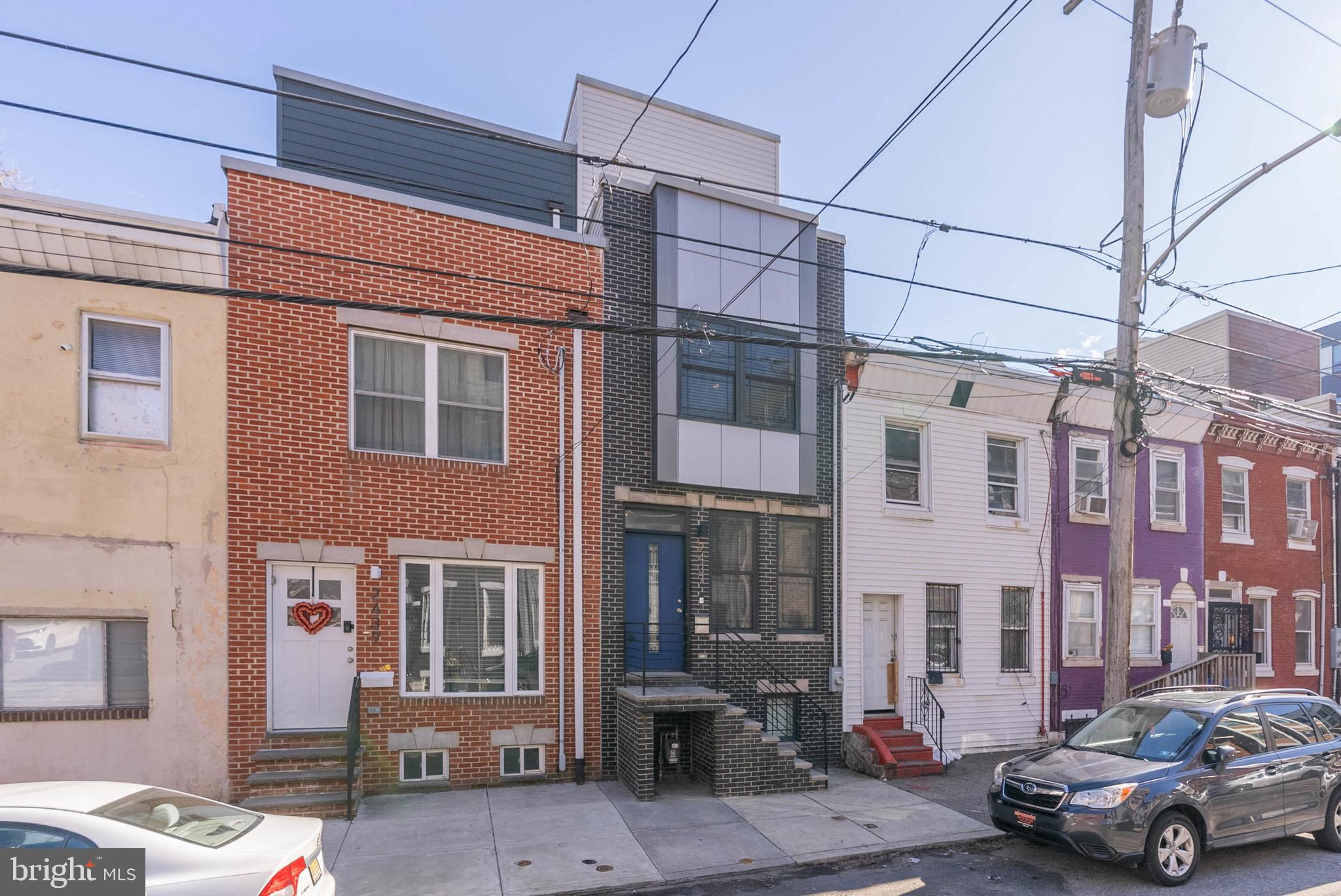 Located steps from popular restaurants, friendly cafes, and sprawling parks, 2437 Jasper St is a newer construction, 3 bed, 3 bath home offering a finished basement, a private patio, a roof deck, and a tax abatement. The front exterior features a towering brick facade, a raised entry, and a vibrant blue door. Inside, you'll step into an open and airy main level framed by tall ceilings and gleaming hardwood floors. A pair of tall windows brighten the living room, while the dining area can fit a table for 6. The heart of the home is surely the all-white, gourmet kitchen fitted with lots of shaker cabinetry, granite counters, stainless steel appliances, a tile backsplash, and a center island with seating. Out back, the fenced patio is the perfect spot for summer barbecues and al fresco dining. More living space and a full bathroom are found in the finished basement, which could be used as a family room, gym, or guest suite. Up on the second level, a large bedroom with hardwood floors, a ceiling fan, and double windows is at the front. A full bathroom, the conveniently placed laundry closet, and another bright bedroom are down the hall. The home's third level is dedicated to the primary suite. There's a sunlit bedroom with tray ceilings, a balcony where you can enjoy your morning cup of coffee, and an attached bathroom boasting a double vanity and a dual-head glass-enclosed shower. A wet bar sits by a final staircase that leads to the expansive roof deck. Here, you can host friends and family while enjoying the skyline views. 2437 Jasper St's utilities include central a/c, gas heat, and gas hot water. In addition to everything inside, this fantastic location earns a Walk Score of 89! Local favorites like IL Sorriso Cafe, OG Pizza, and The Monkey Club are a few blocks away. Neighboring Fishtown has lots to explore, plus nearby shopping centers have essential stores and markets. There's also easy access to public transit, I-95, and South Jersey. Schedule your tour today!