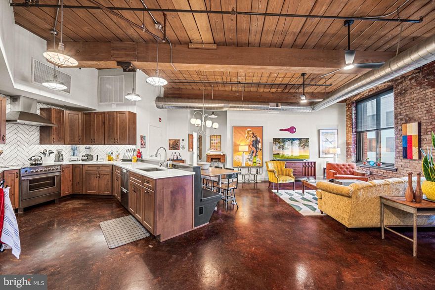 When Industrial meets mid-century modern, you find this stunning 2 bedroom 2 bath loft condominium WITH PARKING at the Cigar Factory. Every detail thoughtfully designed from lights and hardware, to kitchen and baths. The open floor plan with polished concrete floors and exposed brick walls, create a great atmosphere for easy entertaining. The chefs kitchen offers energy-efficient Fisher and Paykel appliances, herringbone backsplash, open concept pull out pantry, fantastic counter space, built in dining bench with electric for the perfect morning, noon or night meal! Off the dining area is a true laundry room with stacked washer/dryer, folding station and cabinetry. The Primary suite is oversized with 2 sun exposures, huge walk-in customized closet plus additional closet, and tiled 4-piece bath with soaking tub, walk-in shower and double sinks. The second bedroom is located on the other side of the home across from the second bathroom offering its own unique style. The unit comes with GARAGE PARKING. The association just installed EV chargers at every parking spot. Located between two vibrant neighborhoods - Northern Liberties and Fishtown. 4 blocks from the Girard EL station to take you into Center City or 30th Street Station. Minutes from great food, fun and activities.