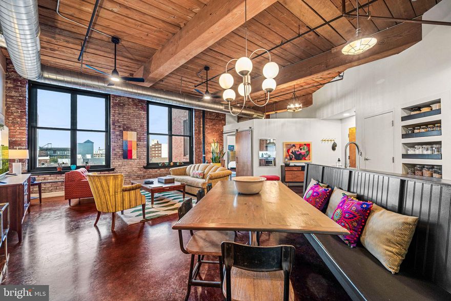 When Industrial meets mid-century modern, you find this stunning 2 bedroom 2 bath loft condominium WITH PARKING at the Cigar Factory. Every detail thoughtfully designed from lights and hardware, to kitchen and baths. The open floor plan with polished concrete floors and exposed brick walls, create a great atmosphere for easy entertaining. The chefs kitchen offers energy-efficient Fisher and Paykel appliances, herringbone backsplash, open concept pull out pantry, fantastic counter space, built in dining bench with electric for the perfect morning, noon or night meal! Off the dining area is a true laundry room with stacked washer/dryer, folding station and cabinetry. The Primary suite is oversized with 2 sun exposures, huge walk-in customized closet plus additional closet, and tiled 4-piece bath with soaking tub, walk-in shower and double sinks. The second bedroom is located on the other side of the home across from the second bathroom offering its own unique style. The unit comes with GARAGE PARKING. The association just installed EV chargers at every parking spot. Located between two vibrant neighborhoods - Northern Liberties and Fishtown. 4 blocks from the Girard EL station to take you into Center City or 30th Street Station. Minutes from great food, fun and activities.