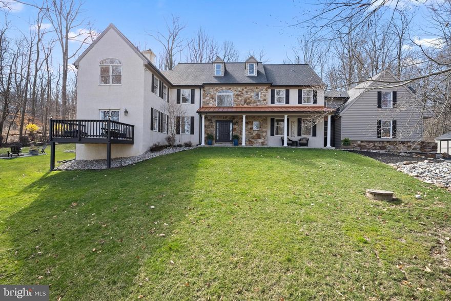 Perfectly nestled on 2.5 acres, 4 Heatherwood Dr is the perfect oasis from the hustle and bustle of everyday life. The stunning scenery as you approach this stately home is both inviting and impressive with mature trees and gorgeous greenery enhancing the warmth and assuring privacy.  Built in 1994 by skilled builder, Roy Raynor, this home is filled with high-quality finishes, including 10ft ceilings on the 1st floor, crown and decorative moldings, custom hardwood floors, high-end wood cabinetry, and more! This home has been well love and carefully maintained by its current owners and features many recent updates, including brand new roof with oversized gutters and downspouts, completely replaced driveway, redesigned landscaping and hardscaping, and new water heater, skylights, LED recessed lighting, carpets, and fresh paint.  Step inside from the charming front porch into the gracious double height foyer which welcomes you to this beautiful 5 bedroom 3 full & 2 half bath home. To the left is the family room with cozy fireplace that connects directly to the large, light-filled home office with a beautiful terrace overlooking the peaceful front yard. To the right is the dining room with crown and chair rail moldings, perfect for hosting large family gatherings all year round. Truly the heart of the home is the open-concept kitchen, breakfast room, and family room area. The kitchen features high-end cherry cabinets, stainless steel appliances, a lovely bay window overlooking the backyard, large pantry, and a peninsula with additional seating. The sunny breakfast area, with skylights and access to the patio and backyard, is warmed by the charming gas stove nearby. The cozy family room also has a fireplace and has access to the side patio with hot tub and fire-pit nearby. Rounding off the first floor is also a powder room and large mudroom with access to the attached 3-car garage.  Upstairs you’ll find the en-suite primary bedroom along with 4 additional bedrooms and 2 full baths. The primary bedroom, with 2 roomy closets, is the perfect place to relax thanks to the gas-burning fireplace and luxurious bath with jetted tub and separate shower. The four additional bedrooms are all extra large (3 can accommodate king-sized beds!) and have fully outfitted closets. Bedrooms 2 and 3 share a huge jack-and-jill bathroom with double sinks and a separate tub and shower, while bedroom 3 has it’s on en-suite bath with hall access and bedroom 5 over the garage is plumbed and ready for its own bath in the future! The laundry room is also conveniently located on the 2nd floor.  This home's day-lit lower level adds extra space for the family to spend time together. It is equipped with a powder room, wet bar, custom built-ins, wainscoting, and large unfinished storage space. Outside, the backyard is the perfect getaway with its grassy yard for kids and pets to play, 2 patios for entertaining, and a large fire pit. Plus, direct access to Horseshoe Trail means you’re just steps away from leisurely strolls in nature. There is also a large storage shed with electrical and lighting, and, for added peace of mind, included in the sale is a generator that runs off the main propane tank.  As if this wasn’t enough to fall in love, 4 Heatherwood Dr. is also located in the top-ranked Great Valley School District and has easy access to major commuting routes and local amenities, including 76, 202, and Route 30, Valley Forge Park, Wegmans, Target, and more!