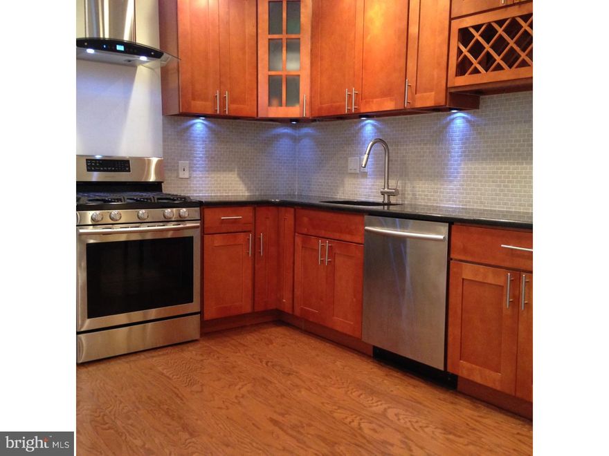 WHAT A VIEW! One of the highest terraces in whole Manayunk offers a BREATHTAKING view over the Schuylkill River Valley. Completely and very tastefully RENOVATED, this distinct stone house on the top of a hill is something else! It is spacious and yet very charming.  Just about everything is new here, including NEW ROOF, new 2-ZONE CENTRAL HEATING AND AIR-CONDITIONING SYSTEM, and new appliances. Exquisite granite and stone materials have been used to renovate the bathrooms and the kitchen.  New wood flooring on the first level, new rich, plush carpet on the second and the third.  All rooms in the house are spacious and all have HIGH CEILINGS even the bathrooms. The first floor boasts a stylish living room with a gas fireplace and big windows adorned with marble windowsills. The living room leads into a lovely kitchen with new maple cabinetry, BLACK PEARL GRANITE countertop, and stainless steel, top of the line appliances. There are two big bedrooms on the second floor. The second floor bathroom is HUGE! It has a beautifully tiled shower stall with a thick glass shower door, and a big JACUZZI!  Two more bedrooms are on the third floor as well as a chic bathroom tiled with black granite and marble inserts. The entrance onto the terrace is from the third floor. Plenty of beautiful recessed lighting and spotlights throughout the house.  The house also has a FINISHED BASEMENT with enough room left for a wine cellar! The backyard looks like a garden with masterfully done brick paths, perennial shrubs, locust trees and a magnificent magnolia tree. Come and see this beautiful place. It truly offers the best of living in vibrant Manayunk!