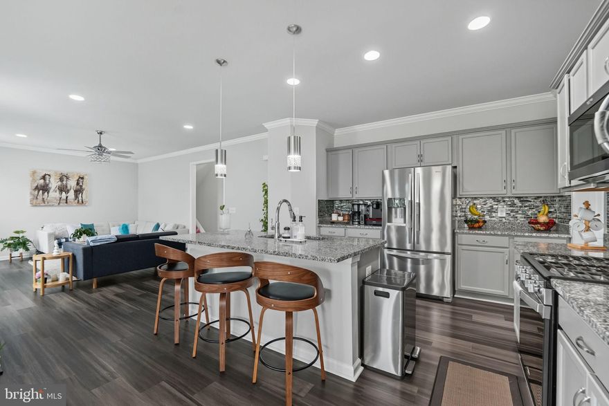 Built in 2021, this modern single-family home in Snowden Bridge offers spacious, well-designed living for today’s lifestyle. The main level is perfect for both everyday comfort and effortless entertaining. A generous living room flows seamlessly into the chef’s kitchen—featuring sparkling granite countertops, stainless steel appliances, pendant lighting above the center island, and a walk-in pantry. Just off the kitchen, the sun-filled dining area is wrapped in windows and opens to the TREX deck, ideal for relaxing or hosting outdoors. Upstairs, a second family room provides a great additional living space. The bright and ample primary suite includes a luxurious ensuite with a walk-in shower, dual-sink vanity, and beautiful tile flooring. Two additional bedrooms and a hall bath, complete the upper level. The fully finished, walk-out lower level adds exceptional versatility, offering recessed lighting, a spacious recreation room, a full bath, and a bright bedroom—perfect for guests, teens, or multi-generational living. Outdoor living shines with a fully fenced backyard, ideal for play, gardening, or simply enjoying the mountain air. Additional features include an EV-ready 2-car garage. Residents of Snowden Bridge enjoy premier resort-style amenities, including a swimming pool with a pirate-themed water park, an indoor sportsplex, dog park, bike track, playgrounds, walking trails, and a community pavilion—all just minutes from Downtown Winchester’s shops, dining, and major commuter routes.