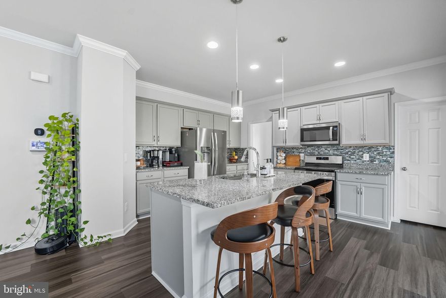 Built in 2021, this modern single-family home in Snowden Bridge offers spacious, well-designed living for today’s lifestyle. The main level is perfect for both everyday comfort and effortless entertaining. A generous living room flows seamlessly into the chef’s kitchen—featuring sparkling granite countertops, stainless steel appliances, pendant lighting above the center island, and a walk-in pantry. Just off the kitchen, the sun-filled dining area is wrapped in windows and opens to the TREX deck, ideal for relaxing or hosting outdoors. Upstairs, a second family room provides a great additional living space. The bright and ample primary suite includes a luxurious ensuite with a walk-in shower, dual-sink vanity, and beautiful tile flooring. Two additional bedrooms and a hall bath, complete the upper level. The fully finished, walk-out lower level adds exceptional versatility, offering recessed lighting, a spacious recreation room, a full bath, and a bright bedroom—perfect for guests, teens, or multi-generational living. Outdoor living shines with a fully fenced backyard, ideal for play, gardening, or simply enjoying the mountain air. Additional features include an EV-ready 2-car garage. Residents of Snowden Bridge enjoy premier resort-style amenities, including a swimming pool with a pirate-themed water park, an indoor sportsplex, dog park, bike track, playgrounds, walking trails, and a community pavilion—all just minutes from Downtown Winchester’s shops, dining, and major commuter routes.