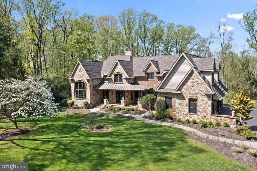 “Luxurious” doesn’t begin to describe it. This stunning stone manor home offers a rare opportunity to experience high end resort-style living in Leopard Lakes, a neighborhood that might be the Main Line’s best-kept secret. From the fabulous first-floor primary bedroom suite to the upper-level game and media rooms, from the finished lower level to the outdoor living room with fireplace and infinity pool overlooking your personal slice of paradise, this 5-BR, 5/2-BA home on 1.4 acres is the ideal setting for an exceptional lifestyle. The location combines the convenience of the Philadelphia suburbs with the feel of a mountain retreat.
Custom built in 2008, this gorgeous home has more than 9,000 sq. ft. of living space and high-end design details—including thick walls, high ceilings and paneled wood doors, arched doorways featuring  stonework and high-gloss woodwork, and large-width hardwood floors. The home is newly painted in neutral tones.
From the brick-paved covered front porch, enter through arched leaded-glass doors into a breathtaking 2-story foyer with Travertine marble floor. Off of the foyer, the dining room, with shiplap beamed ceiling, also opens to the front porch through decorative doors. Also off the foyer, a very chic high gloss, wood-paneled study with arched ceiling features a dramatic chandelier and built-ins.
The living room features a 2-story stone gas fireplace; Palladian windows overlook the rear of the property. The family room has a wood-burning fireplace and offers access to the covered outdoor room with fireplace.
Through a stone archway, the family room flows into the breakfast room overlooking the rear terrace. The gourmet chefs kitchen features a center island with stainless steel and farmhouse sinks and counter seating for 4, a walk-in pantry, and premium appliances, including built in Sub-Zero 30 inch refrigerator with fridge drawers and 30 inch freezer with 2 freezer drawers. Wolf dual-oven stove and 6-burner range with griddle, and 2 Asko dishwashers. A convenient wet bar boasts a Sub-Zero wine cooler, 2 refrigerator drawers and an ice maker.
The first floor also features a laundry room, mudroom and a well planned desk/command center office. Off a separate hallway, enjoy pretty views from a very private primary bedroom suite with new wall-to-wall carpeting, a vaulted ceiling and gas fireplace. The suite includes a sitting room, a dressing room with spacious walk-in closets, and a sumptuous bath with gas fireplace, dual-sink vanity and make-up vanity, water closet, walk-in shower with multiple heads, and a soaking tub.
Upstairs 3 bedrooms all feature ensuite baths and walk-in closets. Also on this level, a spacious game room with bar area and banquette seating, a media room with theater-style chairs and AV equipment and a sitting room with built-in desk are perfect for fun family times (and homework). On the finished lower level, a 5th bedroom with Jack-and-Jill bath is ideal for an au pair or guest suite, and a large bonus room makes a great home gym and hobby room.
The home  has a 4-car attached garage and a fabulous outdoor room with stone fireplace and SunBrite TV, built-in grill and refrigerator, and an adjacent Trex deck with stunning views of the fenced-in yard, surrounding woods and custom Armond infinity pool.
This extraordinary residence is part of a unique community of just 40 homes on quiet streets with no through traffic. Fun activities like pickleball and tennis, fishing, ice skating, swimming in the lake. Visits from Santa, the Devon horse show Clydesdales, Easter Egg Hunts and Happy hours at the lake. This isnt just a home, its also a lifestyle!
Just 2 miles from Rte 30 in Berwyn, close to Wayne, near Episcopal Academy and many country clubs. Quick to Devon and Newtown Square Whole foods, easy access to Amtrak service to NY via Paoli station. Leopard Lakes offers 11 acres of common grounds, a private 6-acre lake, playground, tennis courts and lakeside walking trail.