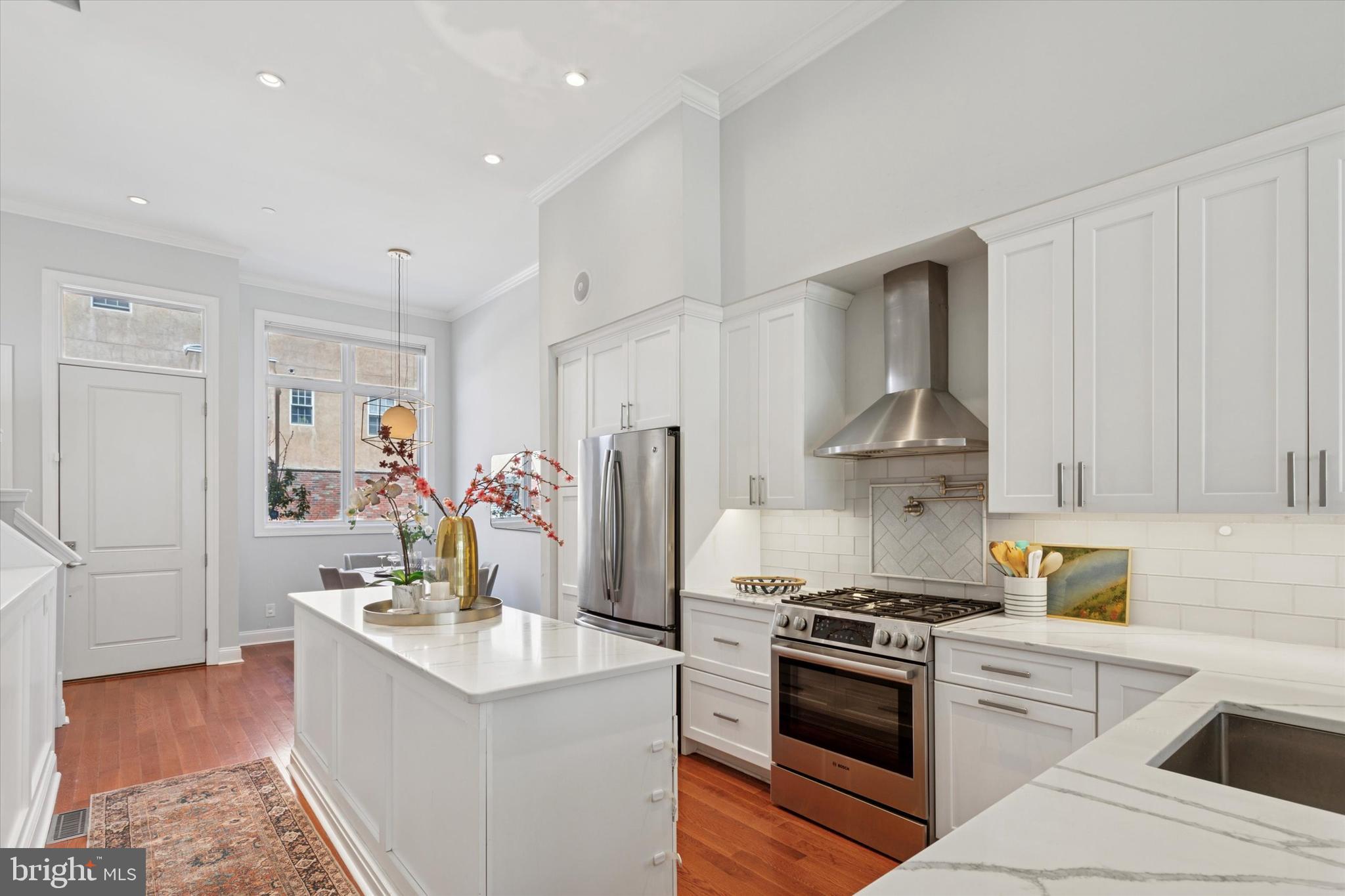 Experience the Ultimate City Living in Spring Garden, Philadelphia
This custom-designed, five-bedroom, three-and-a-half-bath home offers the pinnacle of urban living in the vibrant Spring Garden neighborhood. Spanning four spacious levels, the home boasts soaring ceilings and sun-drenched rooms, creating an inviting atmosphere throughout.
Main Level:
Step into the main living space, where style meets functionality. The open layout features a dining area and a chef’s kitchen equipped with two islands, high-end appliances, and custom cabinetry. The adjoining living room is accented with built-in bookcases and a gas fireplace. A wall of windows and doors opens to the serene back patio, complete with natural slate flooring, built-in irrigation, and speakers. The patio also includes a partially covered area for all-weather enjoyment. Beyond the patio is a 16-foot-wide parking pad with herringbone brick pavers and a secure roll-up door. There is wiring available in the parking pad for a Level 2 EV charger. Additional conveniences on this level include a powder room, a large hall closet, and a built-in package locker with a WiFi lock and keypad for seamless deliveries.
Second Level:
As you ascend the staircase, dramatic skylight views guide your way to the second floor. The primary suite exudes luxury, featuring a cozy gas fireplace, an en suite bathroom with a soaking tub, enclosed glass shower, and double vanity, as well as a spacious walk-in closet. A second bedroom is also located on this floor.
Third Level:
The third floor includes two additional bedrooms, a full bathroom, and an oversized laundry room for ultimate convenience.
Fourth Level:
The top floor is an entertainer's dream, with a second living room offering stunning city skyline views, a wet bar, and a refrigerator for easy hosting. Step out onto the landscaped, irrigated roof deck, featuring no-maintenance Trex flooring and built-in speakers.
Lower Level:
The fully finished lower level includes a guest bedroom, a full bathroom, and a home gym with soaring 9-foot ceilings. A unique feature of this level is a soundproof room with concrete walls and ceiling, pre-wired for 5.1 surround sound, making it ideal for a home theater or studio.
Neighborhood Highlights:
Located in the heart of Spring Garden/Poplar, this home is steps away from childcare options, grocery stores, shopping, and coffee shops. The Broad Street Line is just three blocks away, offering convenient access to the rest of the city. Nearby attractions include popular spots like Café Lift, Osteria, Elixr, La Chinesca, Love City Brewing, The Rail Park, and more. A brand-new local park is only 1.5 blocks away, and Center City is just a 15-minute walk. Easy access to the expressway further enhances the convenience of this prime location.
Don’t miss the opportunity to make this exceptional home your own in one of Philadelphia’s most dynamic neighborhoods.