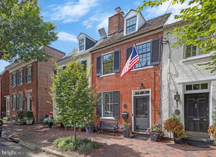 This beautiful townhome in the SE quadrant of Old Town Alexandria has been lovingly restored and thoughtfully expanded.  Gorgeous and move-in ready, it showcases historic charm and designer details throughout - the perfect blend of original features and modern livability.  The circa 1797 living room features the original floors, wood-burning fireplace, and mantel. The chic custom-cut sisal rug (conveys), European art hanging system, and Kable Lite lighting make this an elevated and updated space.  The later addition of the dining room, circa 1820-1830, also maintains original floors, a fireplace, a built-in cabinet, and a coat closet.  Beyond the dining room is an addition, completed in 2020, which is the heart of the home.  The chef’s kitchen offers custom inset cabinetry, a Wolfe range, a Bosch dishwasher, and soapstone countertops.  The elegant wet bar and butler’s pantry include a beverage refrigerator, open shelving, and glass front cabinetry; the threshold was hand-crafted from reclaimed wood original to the home.  Adjoining the kitchen is a spacious family room with a gas fireplace, pine tongue and groove ceiling detail, and access to the backyard. A hyphen hall between the kitchen and dining room is the home to a convenient half bath with exposed original brick, a broom closet, and a built-in bookcase ideal for cookbooks. The upper level offers 3 bedrooms plus a cozy library with an additional original fireplace and built-in bookcases.  The private primary suite has ample closet storage, a spa-like en suite bath with marble counters and a soaking tub, and access to a private terrace with a Sunsetter remote retractable awning.  The second and third bedrooms are located in the original part of the home, one featuring the 4th original wood-burning fireplace.  A second renovated full bath and an Instagram-worthy laundry room are located on the bedroom level.  Enjoy the comfort of radiant heated floors throughout the first and second levels of the addition and the quality of the new Green Mountain Windows, manufactured in Vermont.  The private backyard oasis has a lovely covered porch, attractive hardscaping, lush plantings, and a gate to the back alley for easy access. Located just steps from the Mt. Vernon Trail, the Potomac River, shops and restaurants on King Street, and easy access to National Airport, Metro, and major commuter routes this is a one-of-a-kind home not to be missed!