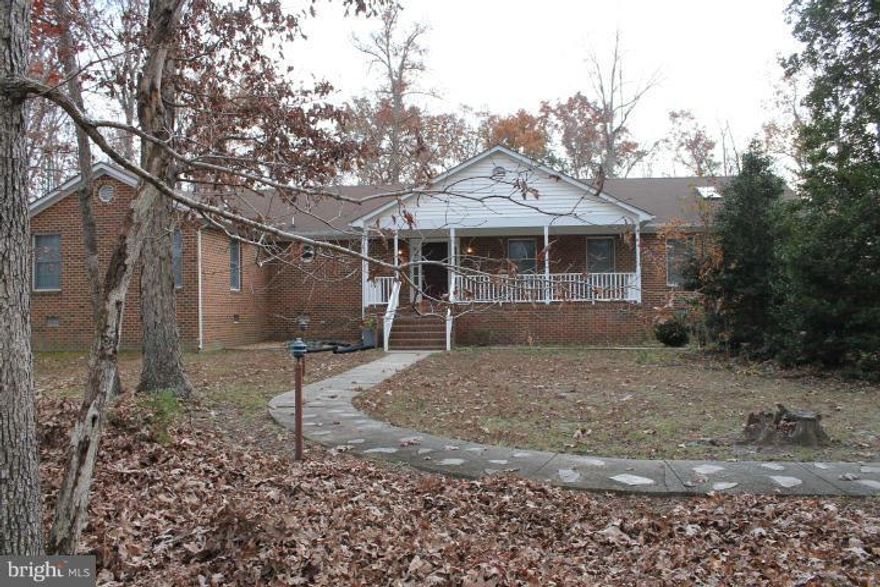 Privacy and wildlife await you. HUGE all brick rambler with gleaming wood floors, vaulted ceilings with sky lights, 2 wood stoves, fresh paint throughout, new carpet in bedrooms, mud room/laundry room w/washer and dryer. Exterior offers large front porch, large back deck and patio with fire pit/BBQ, detached Ginormous out building/garage/workshop surrounded by hardwoods.