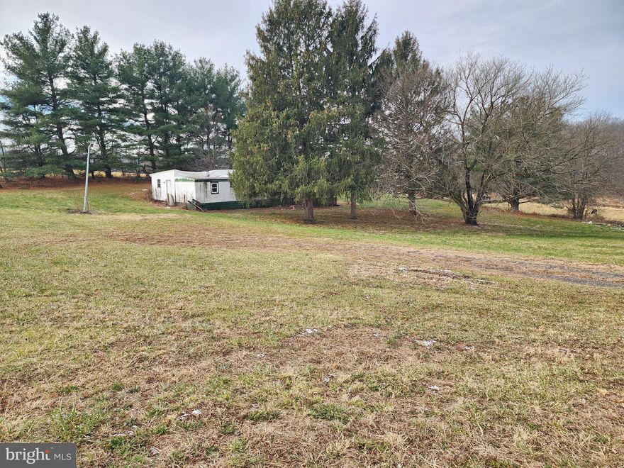 Welcome to 1.14 acres of pure country charm—surrounded by wide-open farmland, rolling views, and the peaceful beauty of rural living. This spacious lot offers a rare opportunity to create your own private retreat, enjoy the freedom of open space, or explore future building potential in a truly picturesque setting.
The property features an older 2-bedroom mobile home that is uninhabitable and unsafe to enter. It will convey As-Is. A well and septic system are present on the property and were in working order when the mobile home was last occupied, approximately four years ago. Their current condition is unknown.
With stunning views in every direction and generous space for your vision, this property delivers the quiet beauty and possibilities that only country living can offer. Call Listing agent for all showings and questions