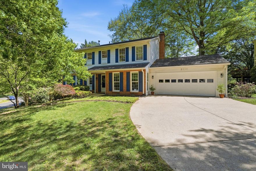 Don’t miss this warm, inviting, one-of-a-kind home in sought-after Barrister’s Place!  A custom top story addition creates a highly versatile layout unlike any other.  Offering over 3,400 square feet of finished space, an additional 300 square feet of unfinished space, and a 550 square foot garage this home easily fits a total of five bedrooms, three full baths, and two half baths across three levels. For those in need of a main level bedroom, look no further!  A beautiful bedroom suite is perfectly located on the main floor along with a separate half bath for guests.  The recently upgraded kitchen features Quartz countertops, white cabinetry, a charming subway tile backsplash, recessed lighting, and stainless steel appliances.  This space includes a sun-soaked eat-in nook with windows on three sides, the perfect spot for a sitting area or a breakfast table.  The oversized dining room is also multi-functional, with a wall of windows and immediate access to the large, main level family room.  All of your furniture can fit here!  Head upstairs to find three bedrooms and two full baths along with zoned heating and cooling, a true upgrade!  With the ability to thermostatically control the top bedroom level independently from the lower two levels, you can guarantee that hot summer days stay outside and sleep remains comfortable.  The massive 18’ by 16’6” owner’s bedroom with beautiful, green views is a true highlight of the home.  A spacious walk-in closet with natural light and a huge owner’s bath complete with double sinks, a large vanity, separate tub, walk-in shower, and separate water closet are incredibly unique features in a home of this kind.  The secondary top floor bedrooms are also generously sized and filled with natural light.  Retreat to the lower walk-out level to find a spacious rec room with recessed lighting and a wood burning fireplace, perfect for cozy nights in.  A bar area and office nook are easily accessible, along with direct access to the fifth bedroom/flex space with built-ins and direct access to the rear yard.  The lower level deck is also accessible through a large set of sliding glass doors.  A bonus half bath, laundry, and tons of storage space can also be found on this level of the home.  In addition to the many wonderful interior features, this charming colonial sits on a HUGE .35 acre (cul-de-sac adjacent!) lot.  Mature, lush landscaping provides green, garden-like views from nearly every window: a beautiful Oak shades the front yard and a truly stunning Sycamore captivates in the back.  The feeling of being away from it all while being conveniently situated in a sidewalk community is ever-present at 2111 Statute Lane.  Located less than a mile to the heart of Vienna’s downtown and a half mile to the W&OD Trail, this location is hard to beat.  2111 Statute Lane feeds to Louise Archer Elementary, Thoreau Middle, and Madison High.  System Notes: Water Heater (2022); Roof (2016); HVAC Top Zone (interior and exterior, model no notes 2013); HVAC Lower Zone (interior and exterior, model no notes 2011); HVAC systems just serviced and service contract is in place; Carpet and Carpet Runner on Stairs (2026); Quartz Countertops (2026); Kitchen Sink and Faucet (2026)