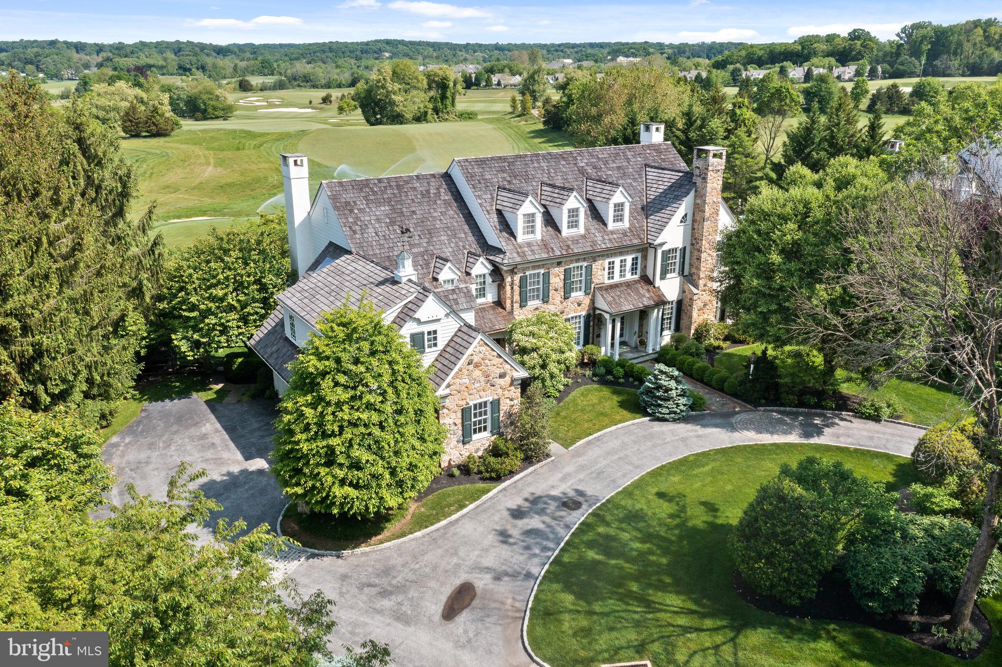 This exceptional Pohlig built 4 (5) bedroom residence perfectly blends sophistication, premium quality construction, and a coveted location overlooking the scenic fairways of Applebrook golf course. Step into this remarkable home through an inviting foyer adorned with beautiful hardwood flooring that spans the entire first floor, exuding an air of luxury. To the right, a formal living room welcomes you with a gas fireplace, creating a warm and inviting atmosphere. French doors open to a home office/library, also featuring a gas fireplace, offering a comfortable setting for work or relaxation. On the left side of the entrance, an elegant dining room flows into a butler pantry complete with a wet bar, providing an ideal space for hosting and serving guests. The kitchen is a chef's dream featuring a large center island, top-of-the-line Thermador wall oven, Subzero refrigerator, Thermador cooktop, and a Miele dishwasher. A breakfast room brightened by natural light offers a delightful spot for meals. The adjacent family room features a third gas fireplace and is complemented by a coffered ceiling. A secondary office, adjacent to the mudroom, leads to the three-car garage. Serving the main level are two powder rooms and a desk area and coat closet in the mudroom. Tranquility awaits on the second floor. The primary bedroom suite features a tray ceiling and spacious dressing room. The primary bathroom is finished with a Jacuzzi tub, a double vanity, and French doors. Abundant storage space is provided by two walk-in closets. The hallway leads to a bedroom with private bath and two additional bedrooms served by a Jack and Jill bathroom. An additional sitting area opens to the laundry room. A versatile bonus room is already plumbed for conversion to a 5th bedroom suite. Easy access to the third floor attic with cedar closet and ample storage is provided by a dedicated stairway. The beautifully finished lower level offers endless possibilities with a game room and family room, catering to recreation and entertainment. A fitness studio is enhanced with a separate full bathroom and steam shower. With its western exposure, the pergola-covered flagstone terrace offers breathtaking views of stunning sunsets. The outdoor space features lush landscaping, a koi pond, and heated swimming pool and spa. The expansive vistas extend over acres of golf course fairways, providing an incomparable setting. The highly desirable location adds to the property's very special appeal. With its generous living spaces, exquisite finishes, and sought-after location, 1667 E Boot Road presents an extraordinary opportunity to own a truly magnificent home in bucolic Chester County.