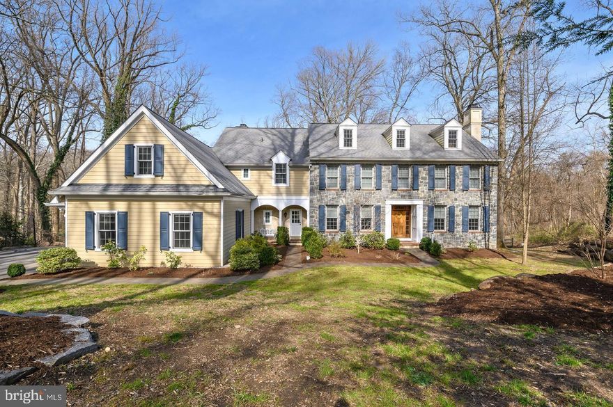 Country Living close to town makes this 5 bedroom, 3/2 bath classic stone colonial on 2.24 acres a dream for those desiring peace, quiet and convenience. Enjoy the idyllic views and serenity of Radnor's Skunk Hollow Park with access to trails and meandering creek stocked with trout for fishing while enjoying a luxury home experience. It is a vacation retreat close to all of the amenities of Main Line living. The attention to detail is evident as you enter the impressive front door into a grand entry hall. Hardwood floors and crown molding grace most rooms. The open floor plan flows into the formal living room with glass transom, fireplace with tasteful millwork and generous windows. The formal dining room has a glass transom, milled wainscoting and access to a butler's pantry with rich cabinetry, granite countertop, a bar sink and glass display cabinets. The stunning white kitchen with granite countertops and a contrasting island boasts arched openings and doors to the breakfast room and fireside family room. Access to the deck is through sliders in the breakfast room and the office. The study sits across a hallway from the living room. Ascend the grand staircase to the second floor landing with a statement window and built-in shelving creating a cozy window seat. The main bedroom has a large sitting room and an en-suite bath. There are 4 additional bedrooms and 2 full baths on this level as well as a large laundry room. There is also a third floor flexspace perfect for a playroom! The possibilities are endless to finish the lower level that opens out to a stone patio with a built-in fireplace and grill area perfect for summer evenings, making s'mores and staying warm on chilly nights. There is a 3 car garage. This house has too many beautiful details to mention but the crowning glory is the stunning wooded lot with grass areas and  naturally placed stone walls. 53 Paper Mill Lane is within minutes of Wayne, Paoli, and Bryn Mawr offering easy access to Center City or hop on Amtrak to New York City. It is also located near Aronimink Golf Club and The Episcopal Academy, this house waits for new memories to be made!