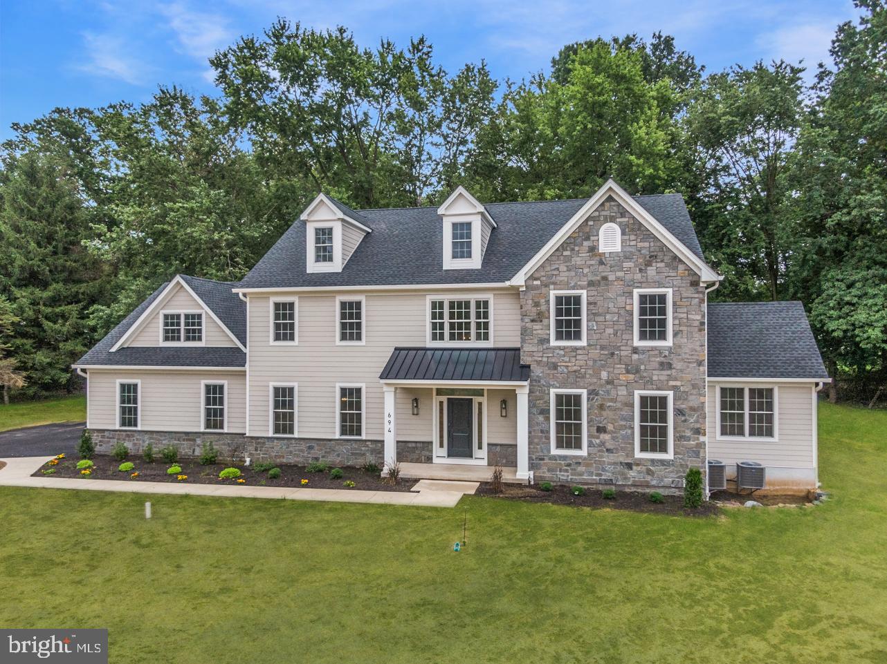 Welcome to this beautifully designed, custom built home in the heart of desirable Blue Bell and the highly sought after Wissahickon School District. You'll love the seclusion of this private wooded lot situated in an exclusive 3 lot community. Upon entering you'll immediately notice the attention to detail and beautiful upgrades throughout that make this home truly special and one of a kind. The dramatic 2 story foyer boasts an upgraded chandelier and onsite finished stunning white oak hardwood floors that flow throughout the first floor, upstairs hallway and master suite. The gracious living room features a shiplap ceiling and flows into the spacious family room featuring a gas fireplace with custom shiplap surround and an adjacent double door entry leading into the tucked-away office featuring a decorative shiplap wall. The magnificent kitchen is every chef's dream featuring 42" custom cabinetry with upgraded crown molding, beautiful quartz countertops, gradient tile backsplash, upgraded Jennair stainless steel appliances with a 6 burner range and custom range hood plus a walk-in pantry and butler's pantry with wine fridge. You'll love hosting holiday dinner parties in the gracious dining room featuring a coffered ceiling and upgraded chandelier. One of the best features of the home is the mudroom featuring a powder room with upgraded decorative tile, shiplap walls and everyone's favorite cubbies with hooks which leads to the oversized 3 car garage with openers. Step upstairs into the luxurious master suite featuring white oak hardwood floors, a shiplap wall, 2 walk-in closets with custom-built organizers and a stunning master bath featuring an oversized shower with upgraded shower heads, a freestanding slipper tub, quartz top double bowl vanity, upgraded fixtures, and a separate toilet room. To complete the 2nd floor you'll also find a princess suite with a luxurious bath featuring an oversized shower, 2 additional spacious bedrooms, a gorgeous upgraded hall bath with upgraded tile and a dream laundry room with upgraded tile floor and cabinetry. The upper level also includes a finished 3rd floor with upgraded carpet, custom cabinetry, closet, and its own HVAC system. And wait there's more! The finished walkout lower level is perfect for a 2nd office or home gym, a 2nd family room plus a beautiful full bath, and an enormous storage room. Additional features of this magnificent home include 2 powder rooms on the first floor, Andersen double-hung windows, the exterior boasts Hardi plank siding, natural stone, and a 25-year architectural shingle shows the quality of materials in this home is much more sophisticated than your typical builder grade. The location is unrivaled and so convenient to the Center Square Shopping Center and HomeGoods shopping center and the ever popular restaurants - El Sarape, Panache, The Blue Bell Inn and Castello's. This is one you won't want to miss!