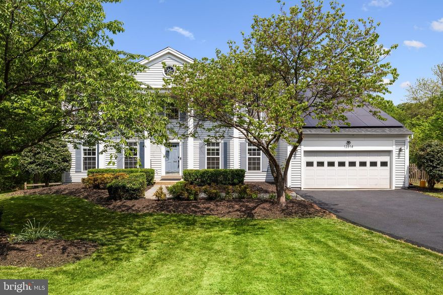 Straight out of a magazine and ready to be Yours! No detail was overlooked in this beautifully remodeled home nestled on a private pipe-stem in sought-after Dranesville Estates.   Whole home and fully paid off solar system provides year round savings, even getting paid for power feeding back into the grid. Prominent pillars supporting the covered portico, paver stone walkway, a manicured flat front lawn/landscaping, and an oversized and newly sealed driveway leading to an ample 2 car garage welcomes you home.  Newer roof(2022), Newer HVAC(2023), Newer water heater(2019), and Newer sump pump for worry-less living.  With over 4300 finished square feet, the open concept interior is an environment of refined authenticity and elegance with stylish and durable wood floors; remodeled bathrooms with dual vanities, tub to ceiling polished porcelain tiles and oversized tubs;  upgraded light fixtures and ceiling fans; crown and chair moldings plus shadow boxing; plenty of recessed lighting; and a fresh neutral color palette throughout ready for your personal touches. The newly remodeled gourmet kitchen is a chef’s and entertainer’s dream, boasting two islands with ample seating; quartzite countertops; stainless steel appliances and range hood; counter to ceiling backsplash; and opens to a long living room ready for game night or a quiet evening in next to the cozy fireplace. The main level office/flex room with custom built-ins, mud/laundry room, formal living and dining room complete the impeccable main level. Upstairs you’ll find 4 large bedrooms to include a luxurious primary suite with vaulted ceilings, 2 large walk-in closets, and a spa-like en suite bath with two vanities and a sleek black frame glass shower and oversized soaking tub. The newly finished walk-out basement has a sprawling rec room with luxury vinyl plank floors, 5th bedroom/flex room,  rough-in for future bathroom and plenty of storage. Attic flooring installed for even more storage.  Enjoy countless evenings letting your stresses fade into the sunsets or grilling with friends and family on the newly stained, sealed and huge deck and concrete patio overlooking a fenced backyard and wooded area leading to trails and streams. Quiet yet engaging community just minutes to groceries, restaurants, parks, and major commuting routes.   Assumable VA loan at 2.25% for qualified VA buyers only.   Simply Pristine!